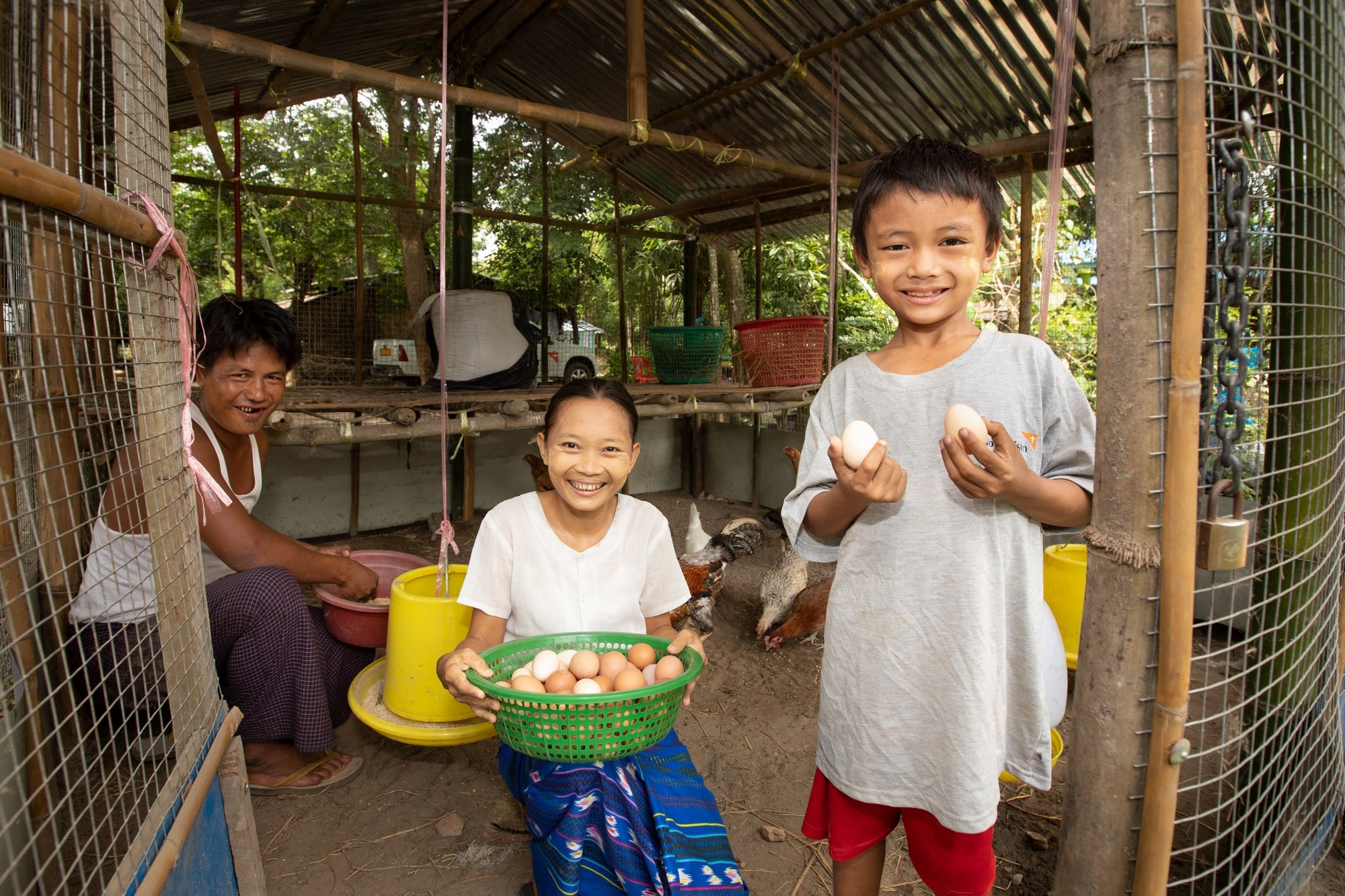Children in Myanmar smile as they hold the eggs that provide food and livelihoods for their family