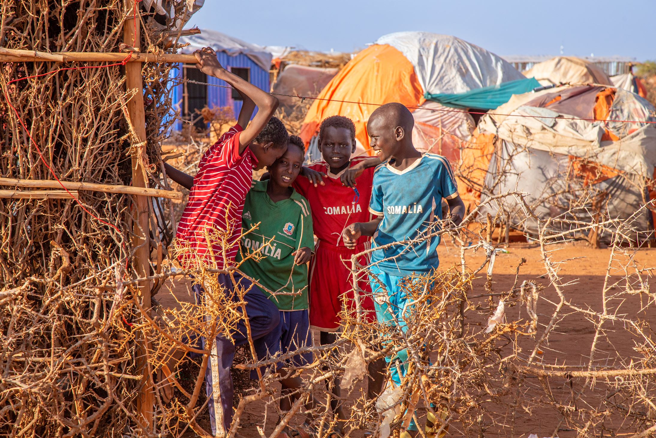 Group of boys playing outside in displacement camp, Dollow, Somalia