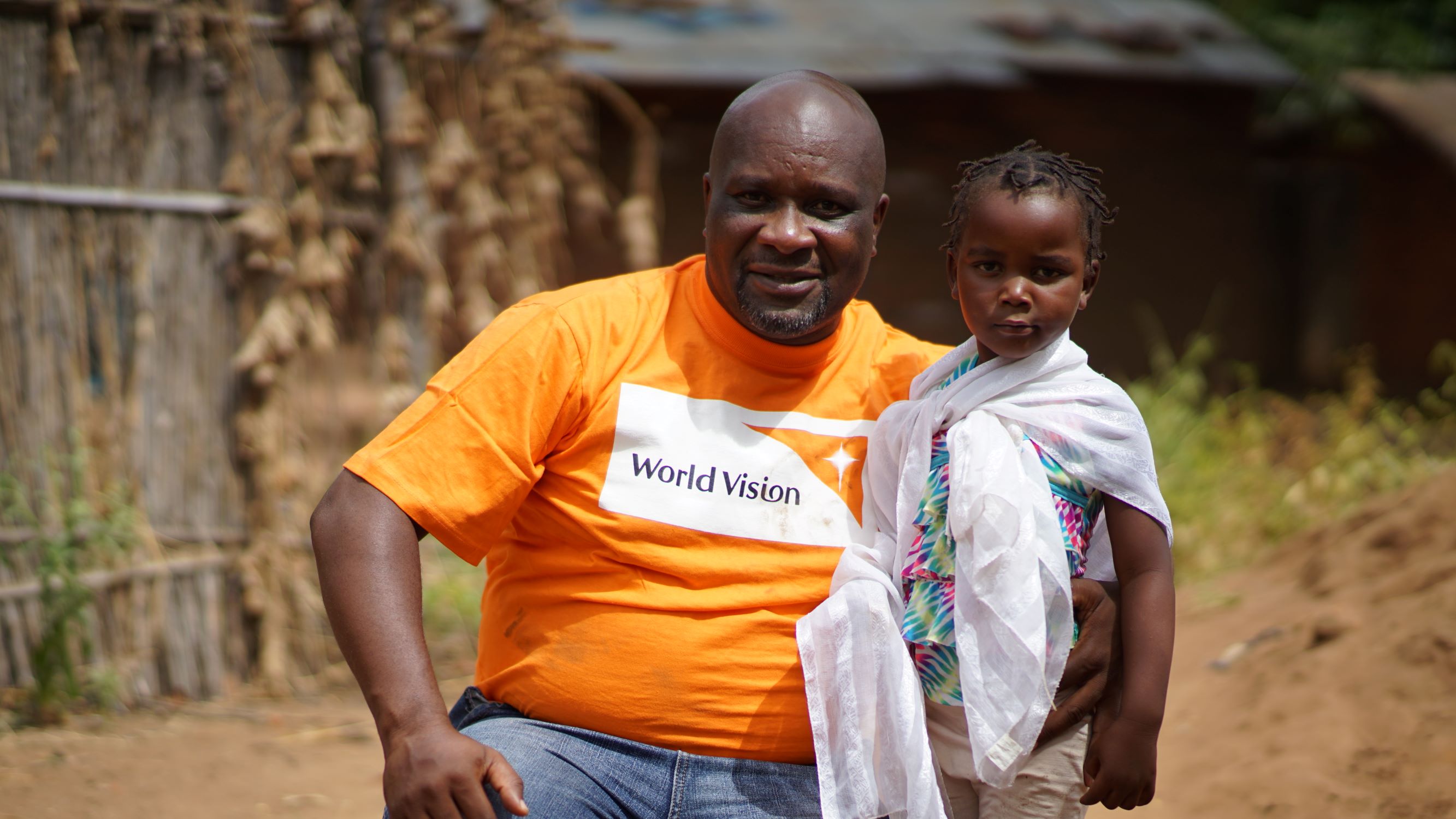 World Vision staff member pictured with a child in Malawi 