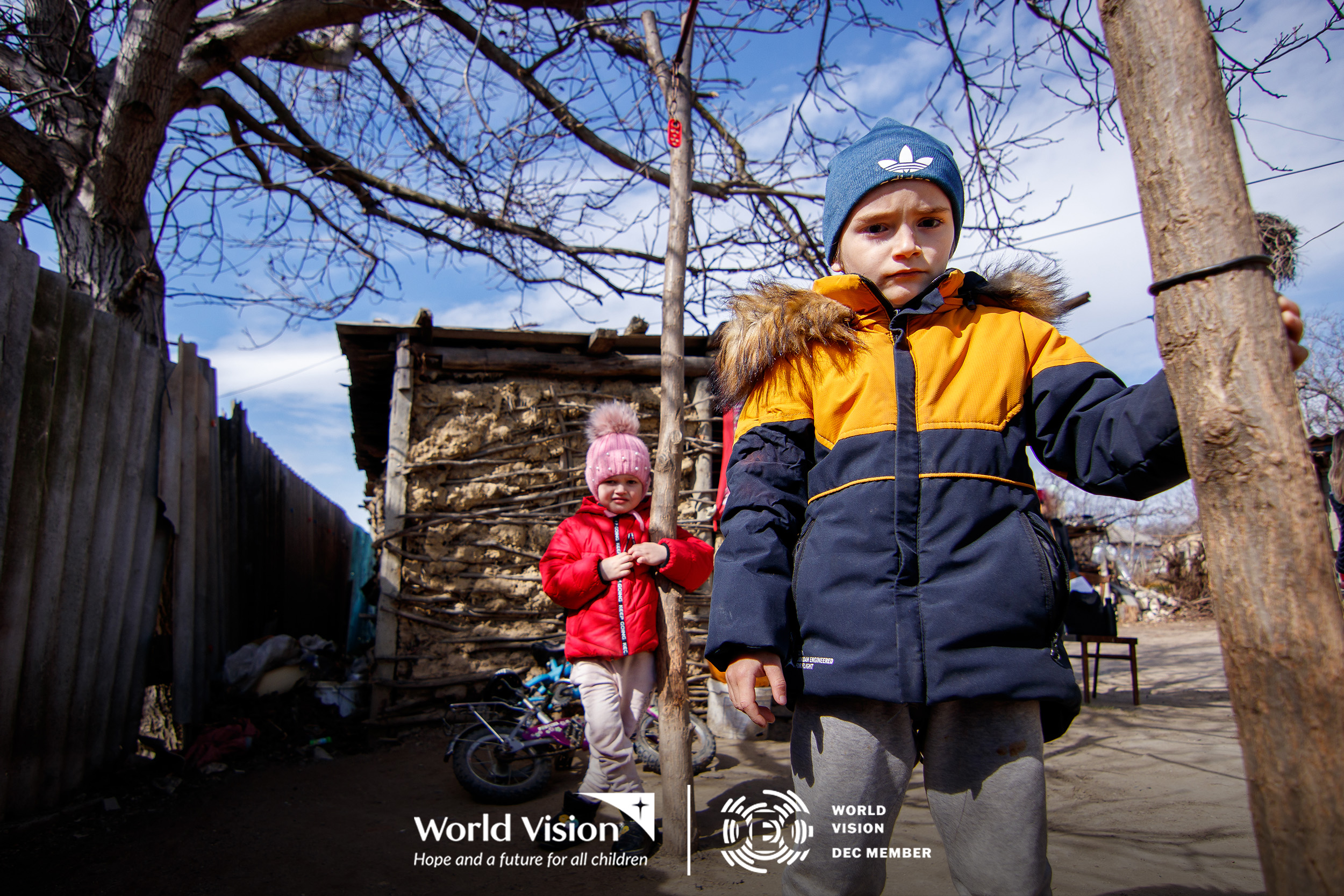 Two Ukrainian children outside their temporary home