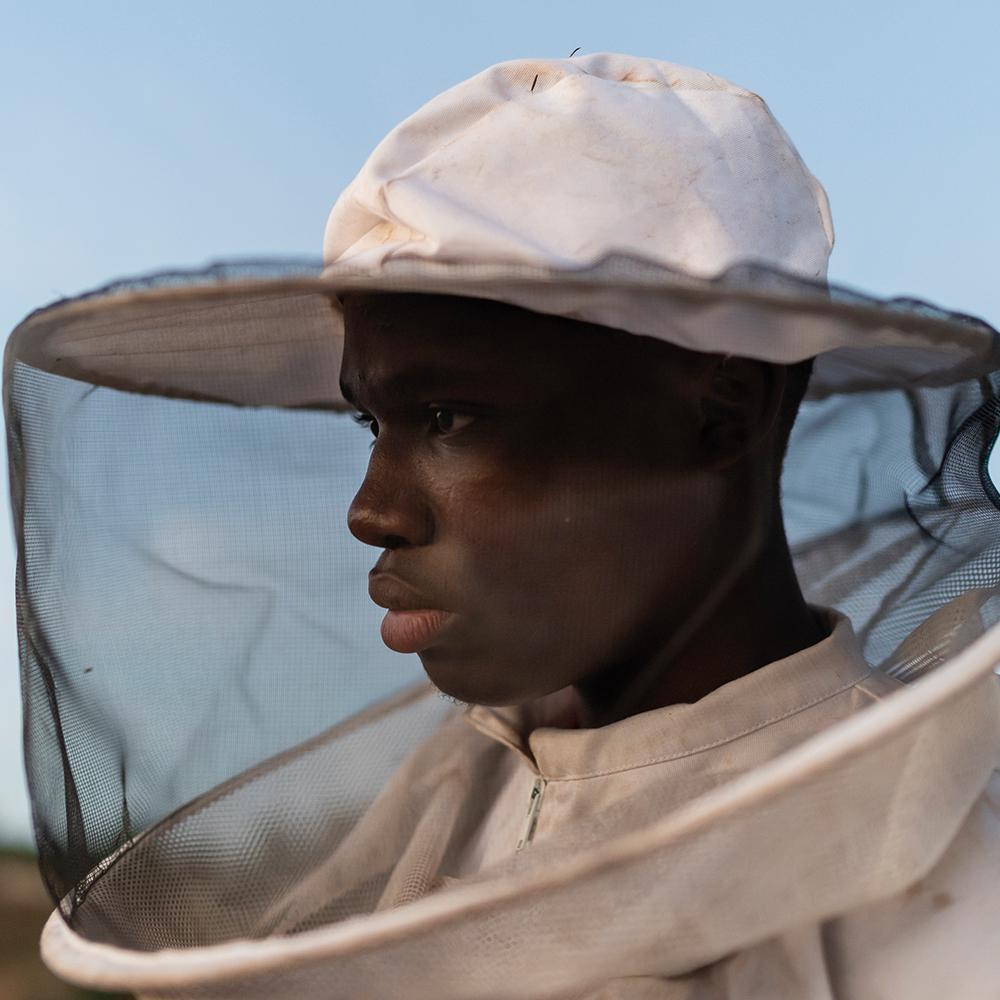Philani in his beekeeping suit, who now has nine bee boxes