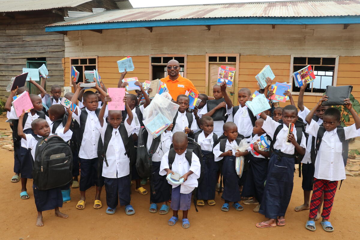 Schoolchildren in the DRC celebrating when receiving World Vision school kits 