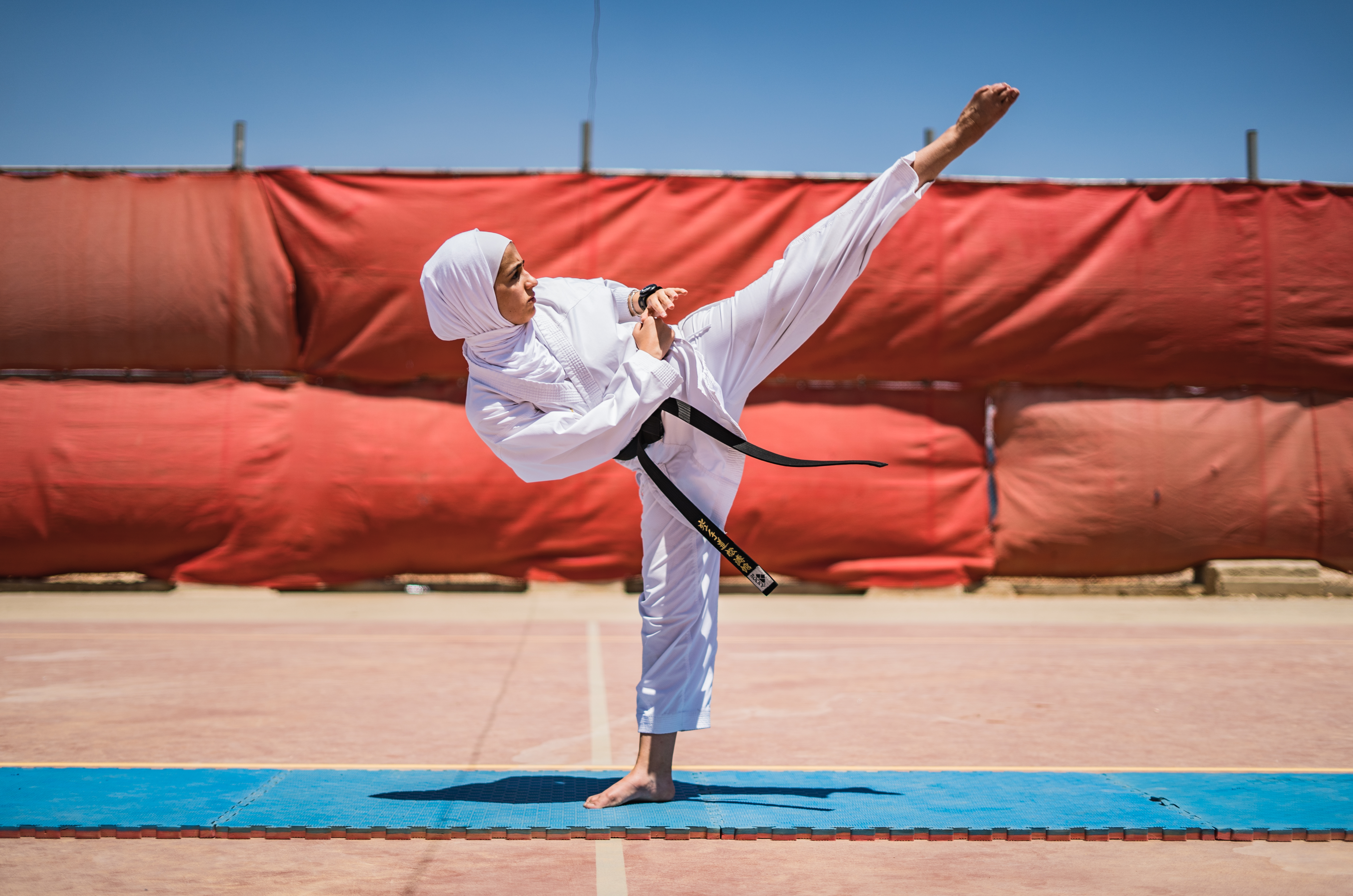 Girl demonstrates karate move in refugee camp in Jordan