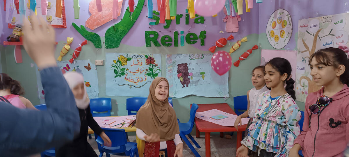 Young girls smiling and playing in Child Friendly Space, Syria