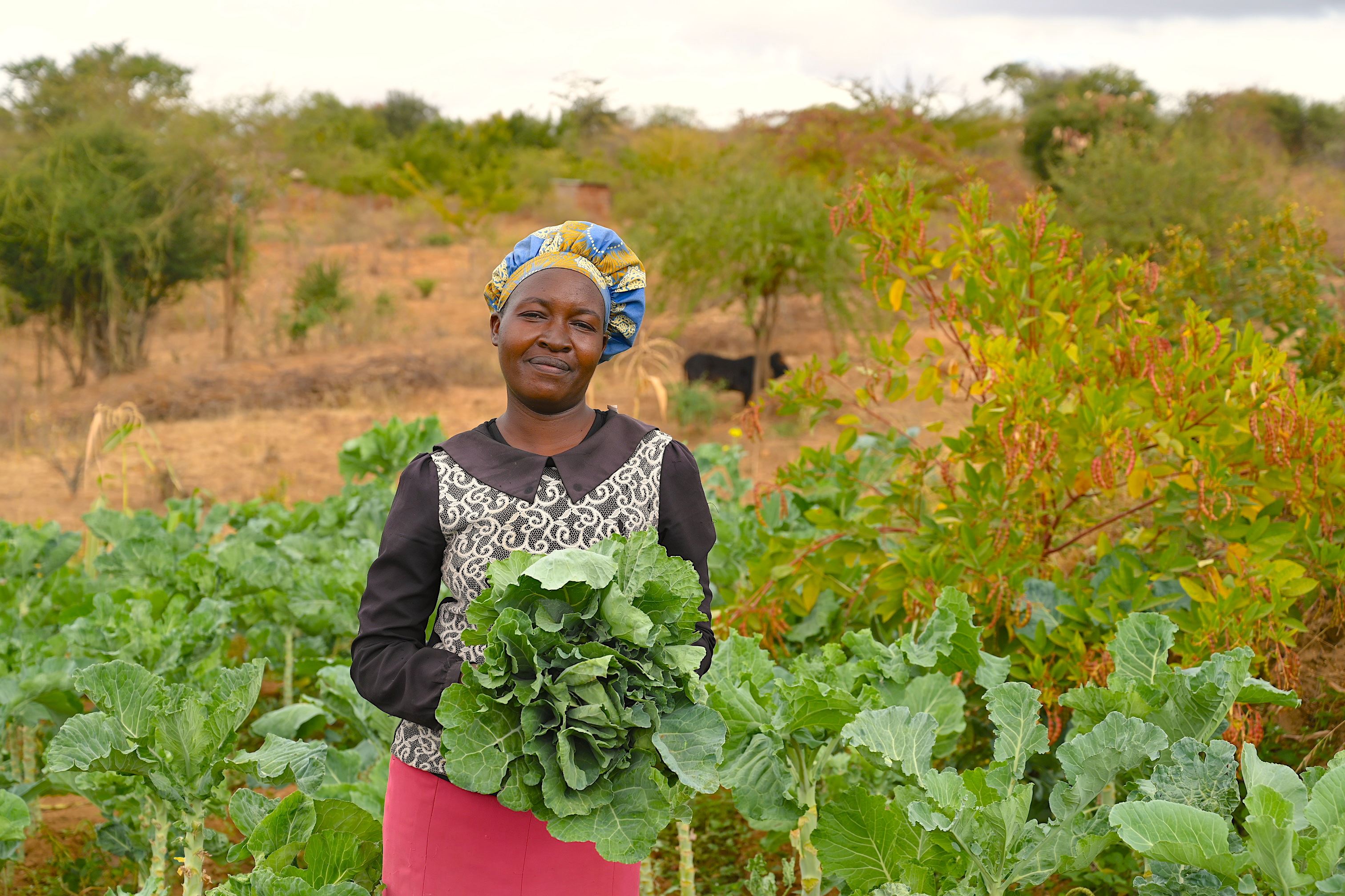 Jennifer showing the vegetables she has grown