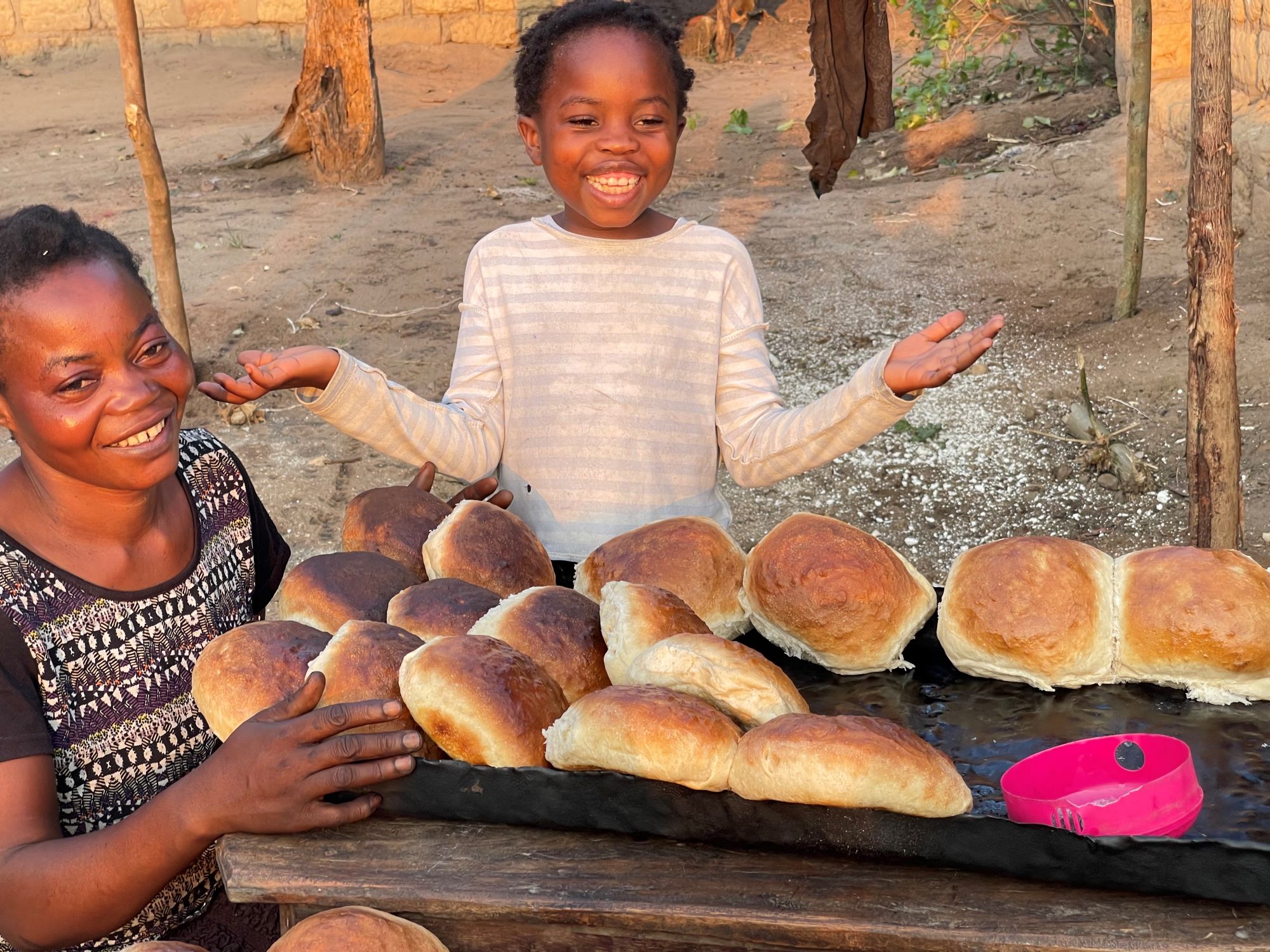 Mother and daughter behind fresh bread in DRC