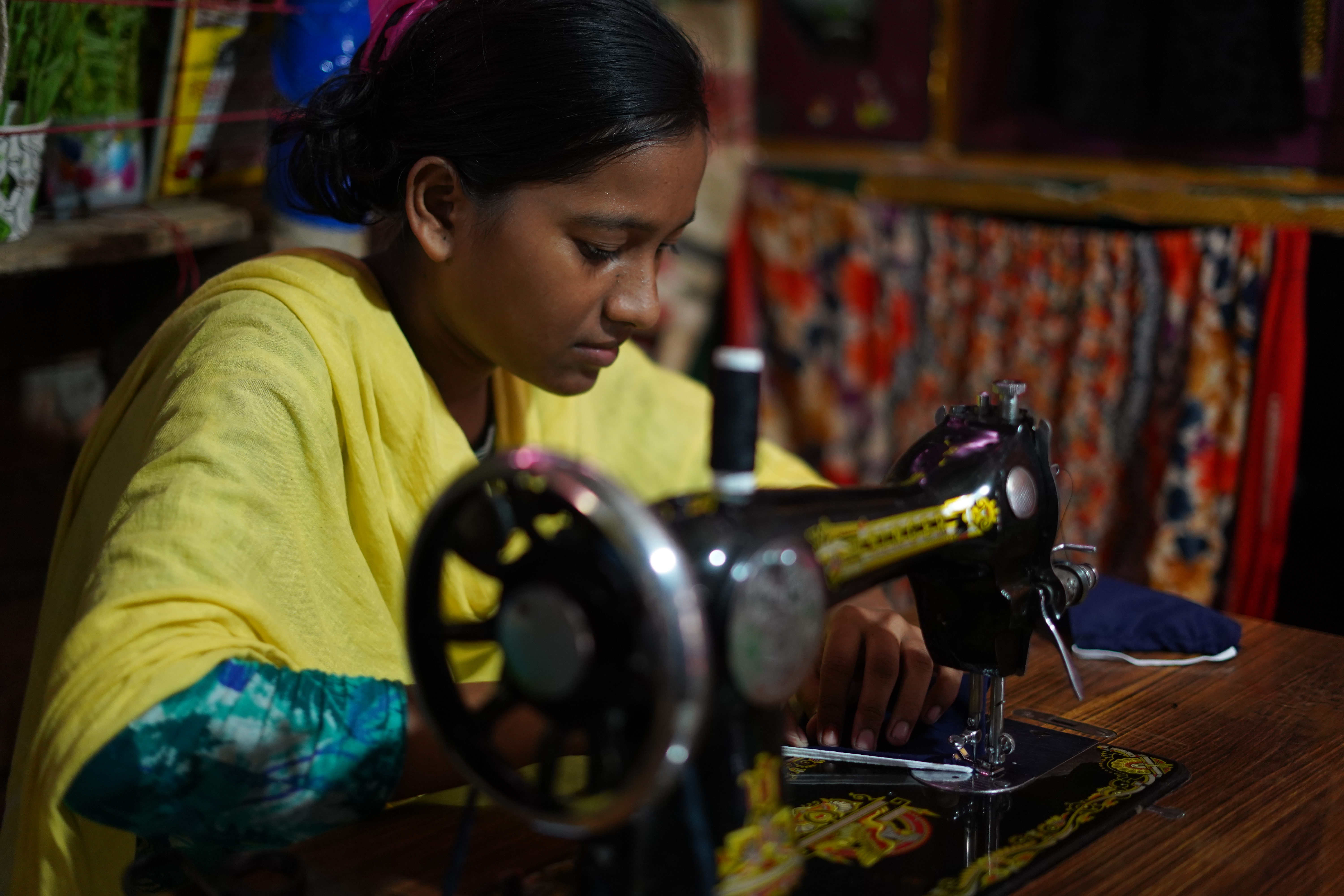 Girl at sewing machine in Bangladesh
