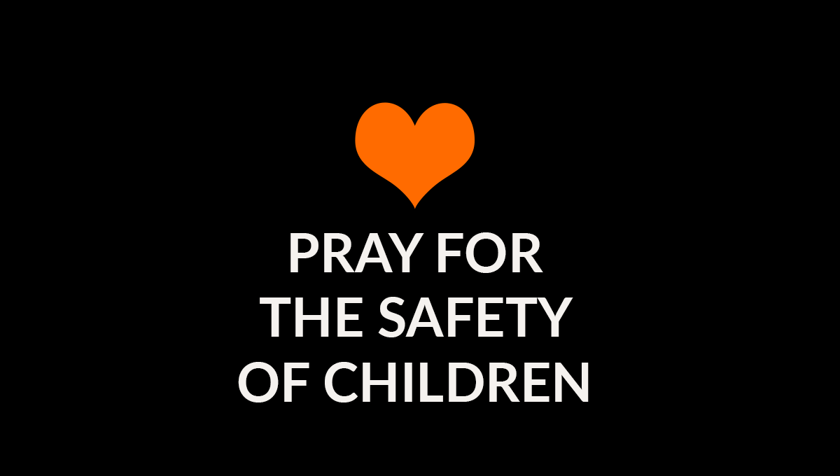 Orange heart on black background with words with words Pray for the safety of children
