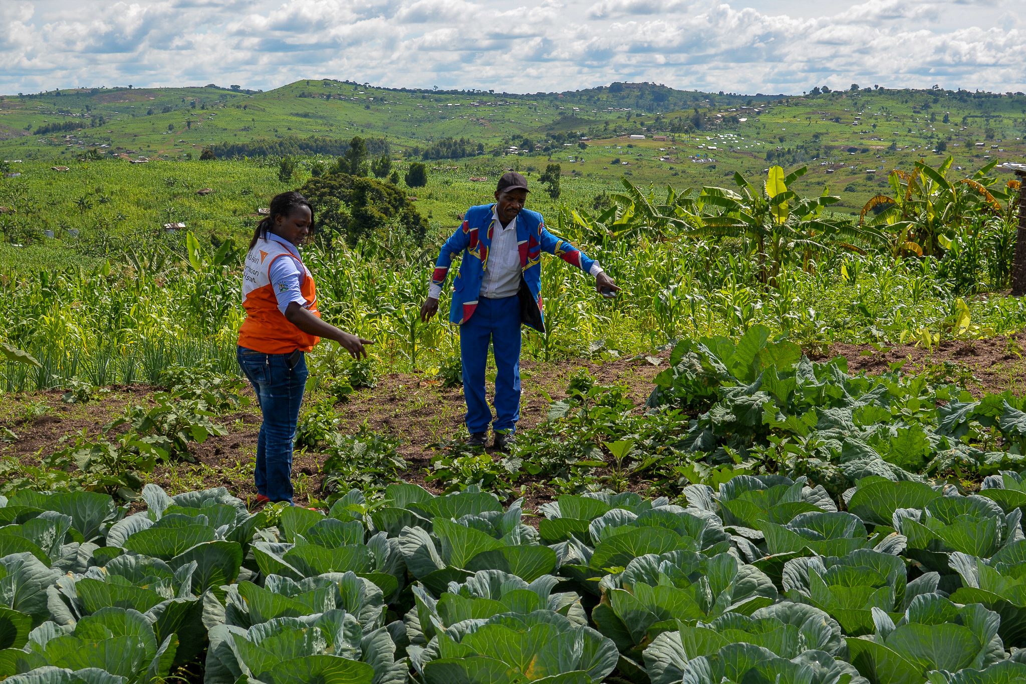 Man and woman next to crops in Uganda field