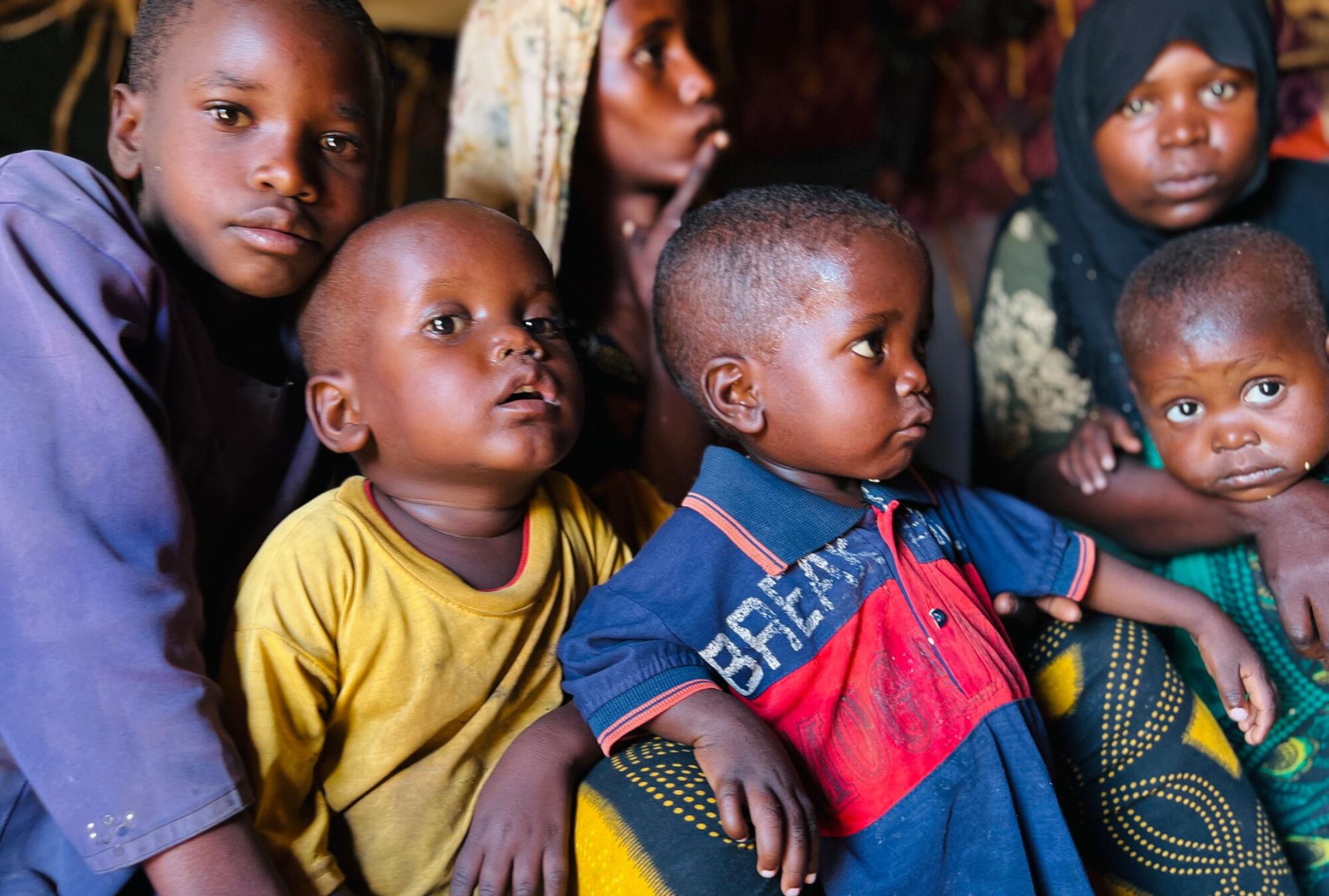 Somali family sat together inside their makeshift home