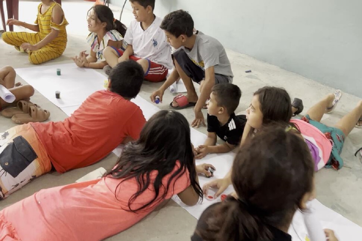 Young child by a pile of rubbish