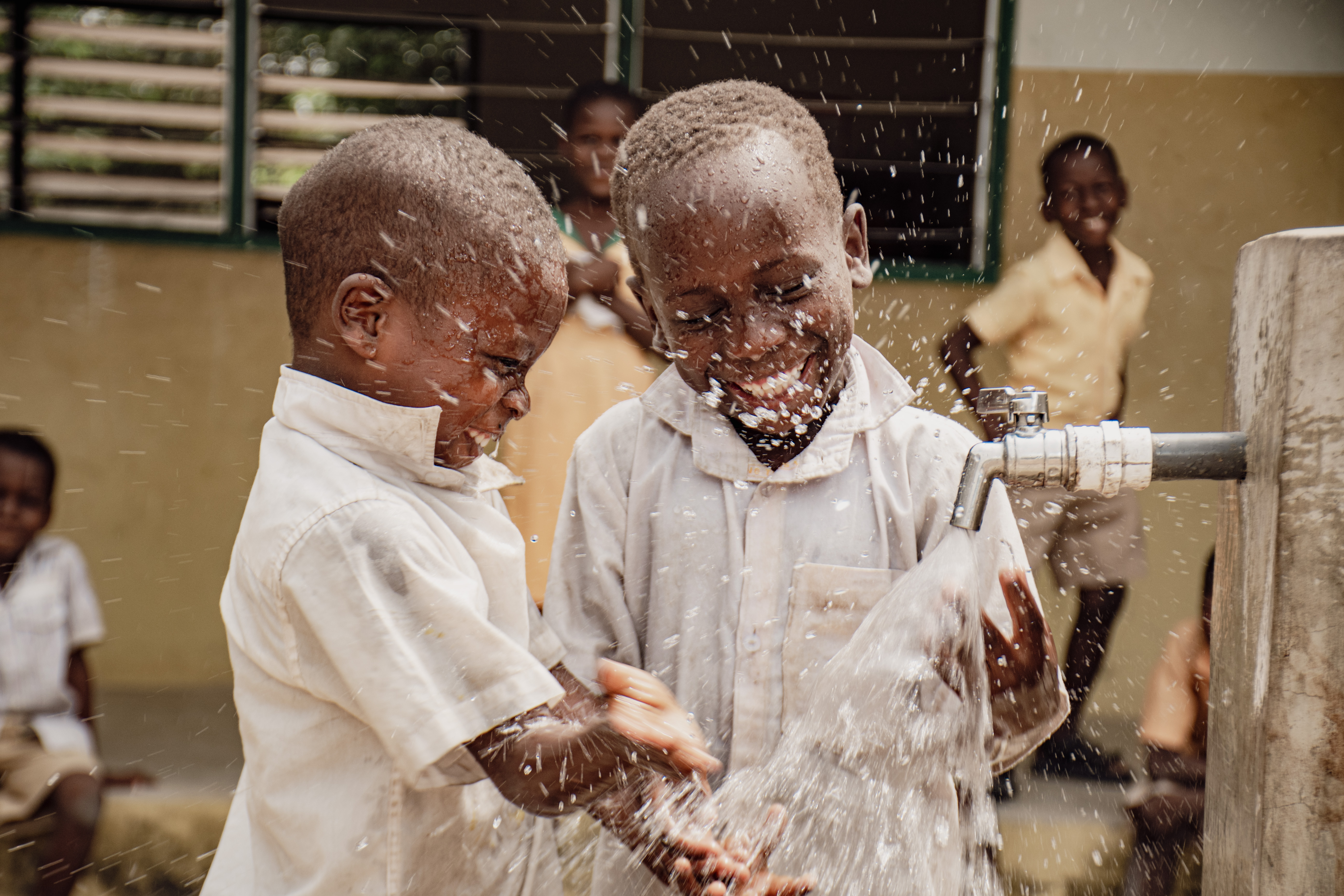Happy children by a borehole in Ghana