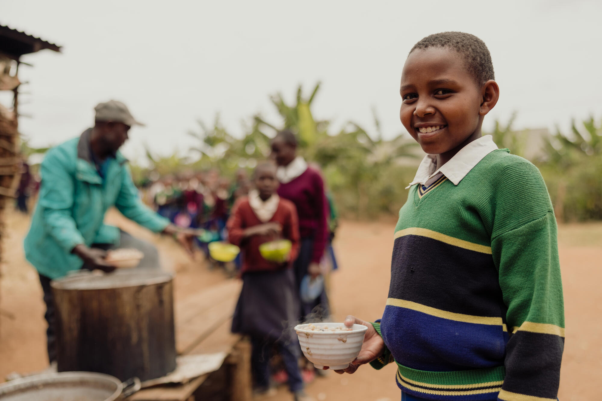 Joanitha enjoys food prepared at a World Vision nutrition club at her school.