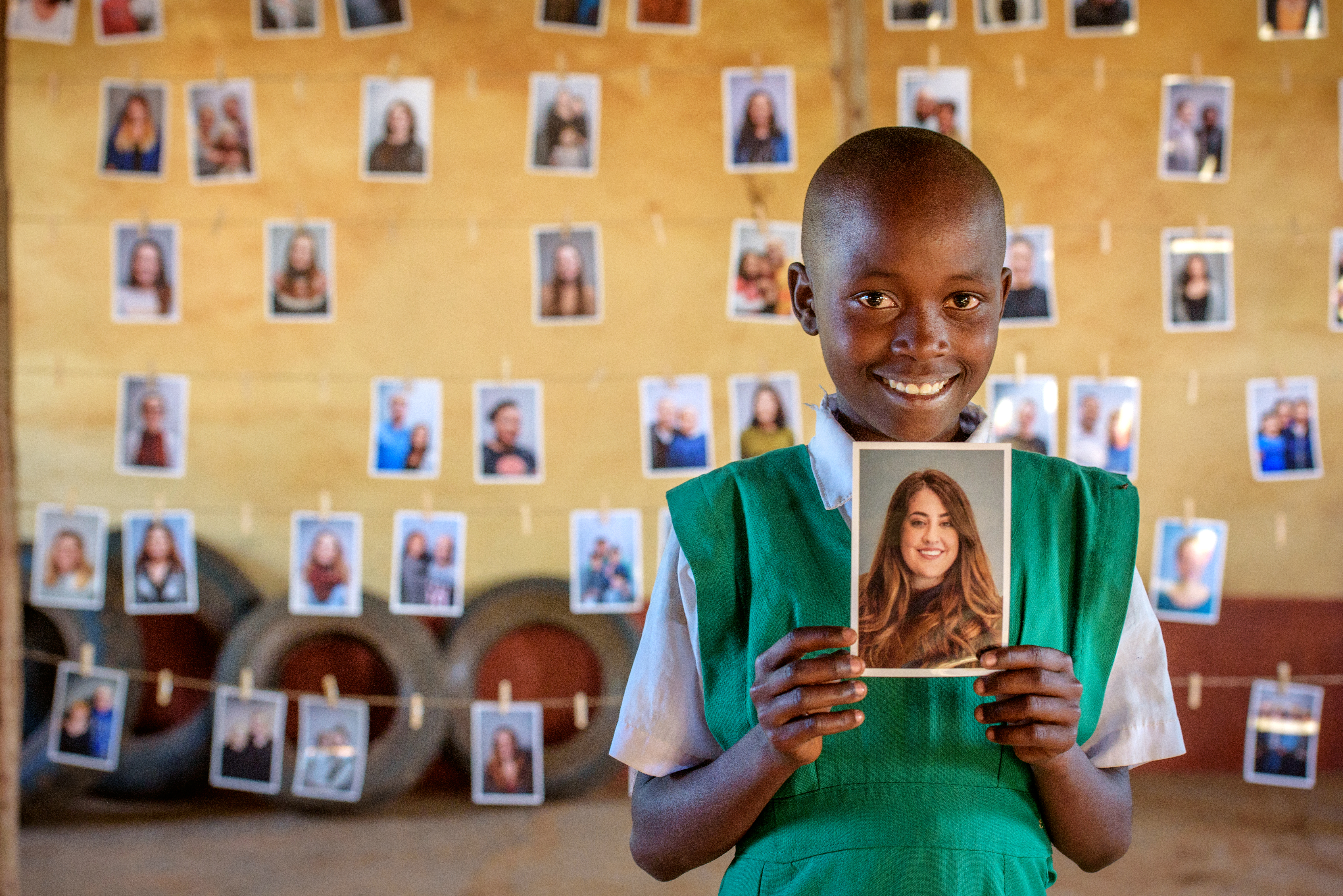 Young girl holding photo of the person who will be her sponsor 