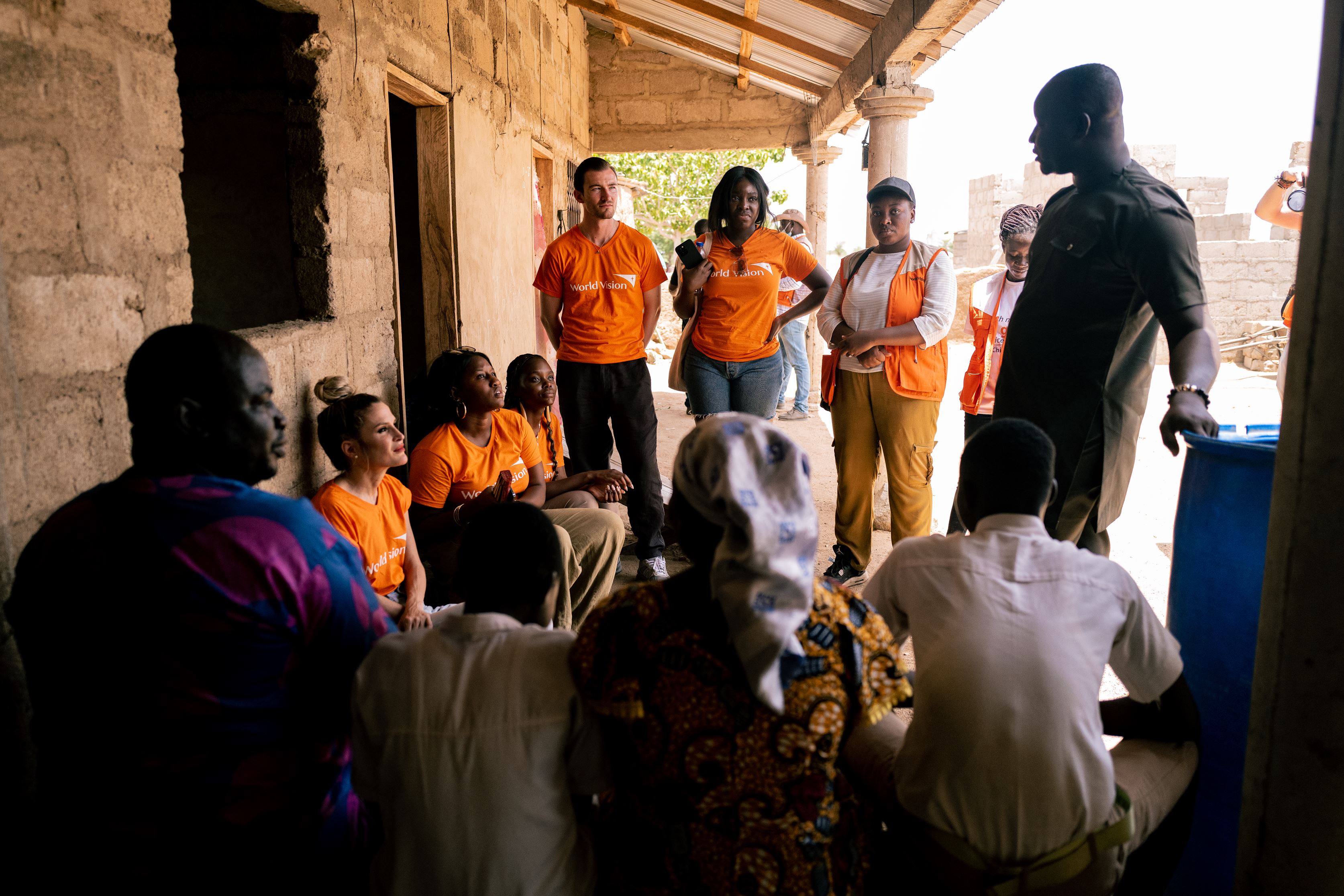 Brett and group of creators speak to locals under a canopy