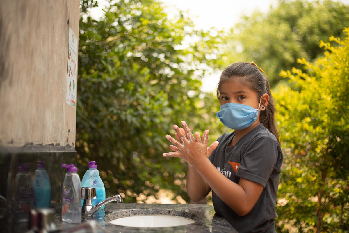 Rosa, in Bolivia, shows the correct way to wash hands to prevent diseases like COVID-19.