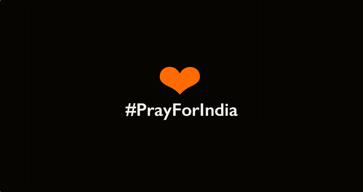 Orange heart on black background #PrayforIndia