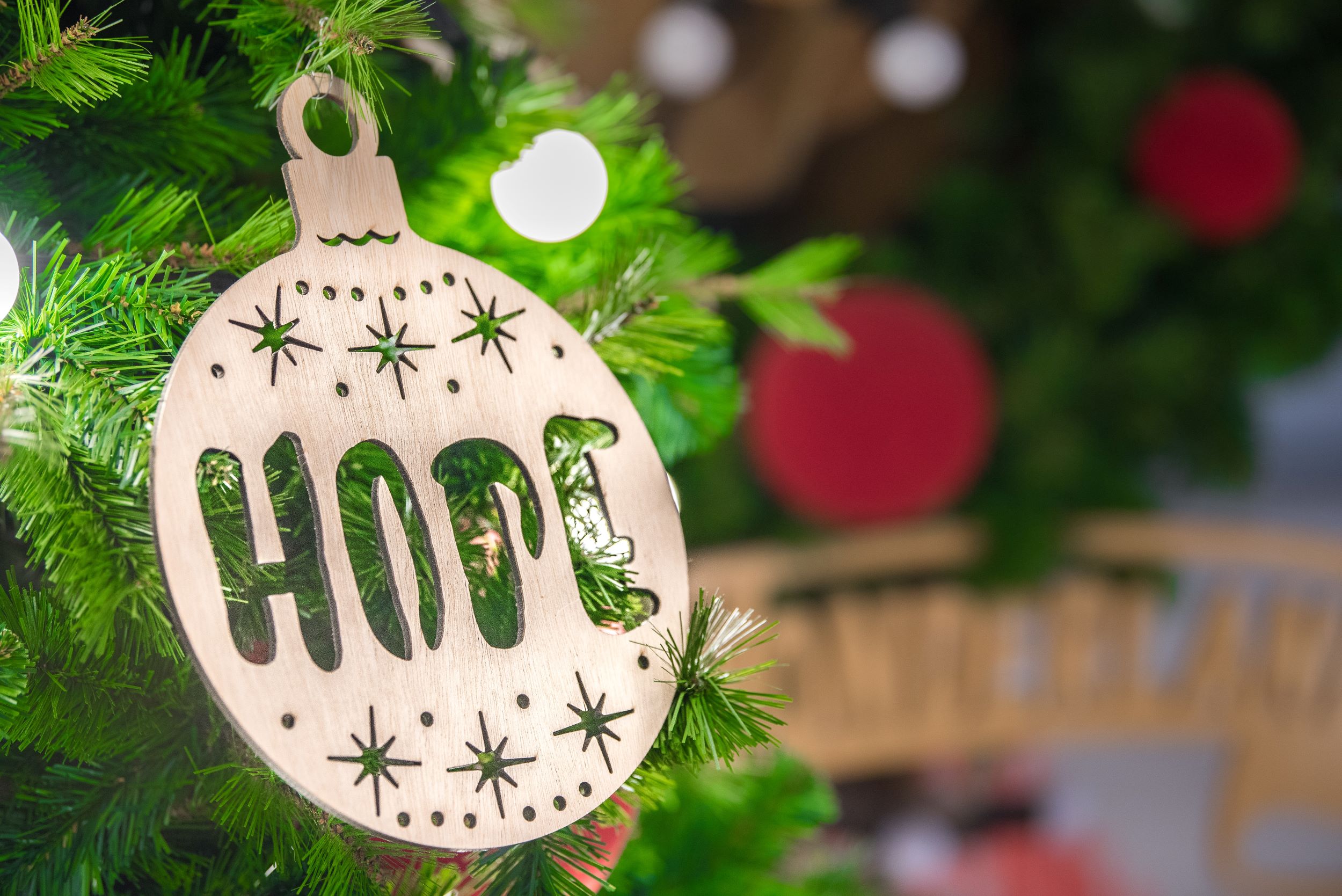 Wooden hope ornament on a Christmas tree
