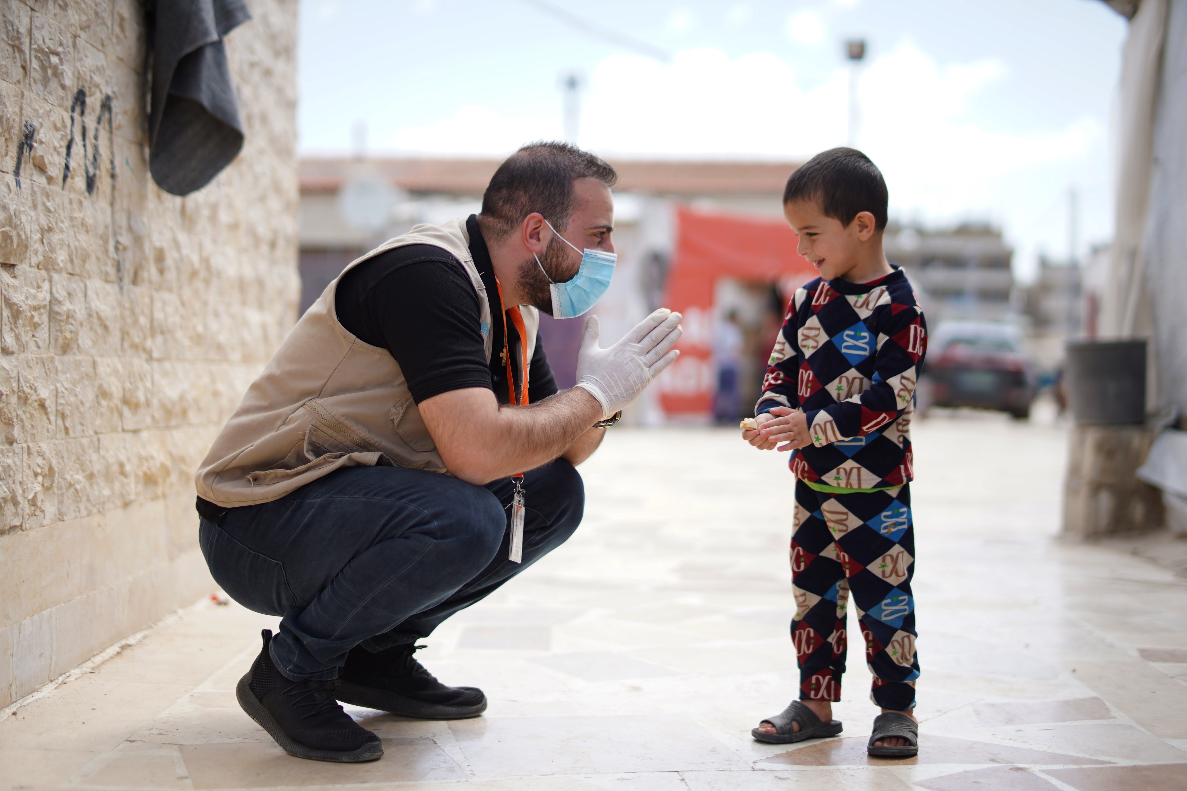 A member of the World Vision's team in Lebanon makes a friend whilst doing our work distributing door to door bleach and sanitizing products to the Syrian refugees