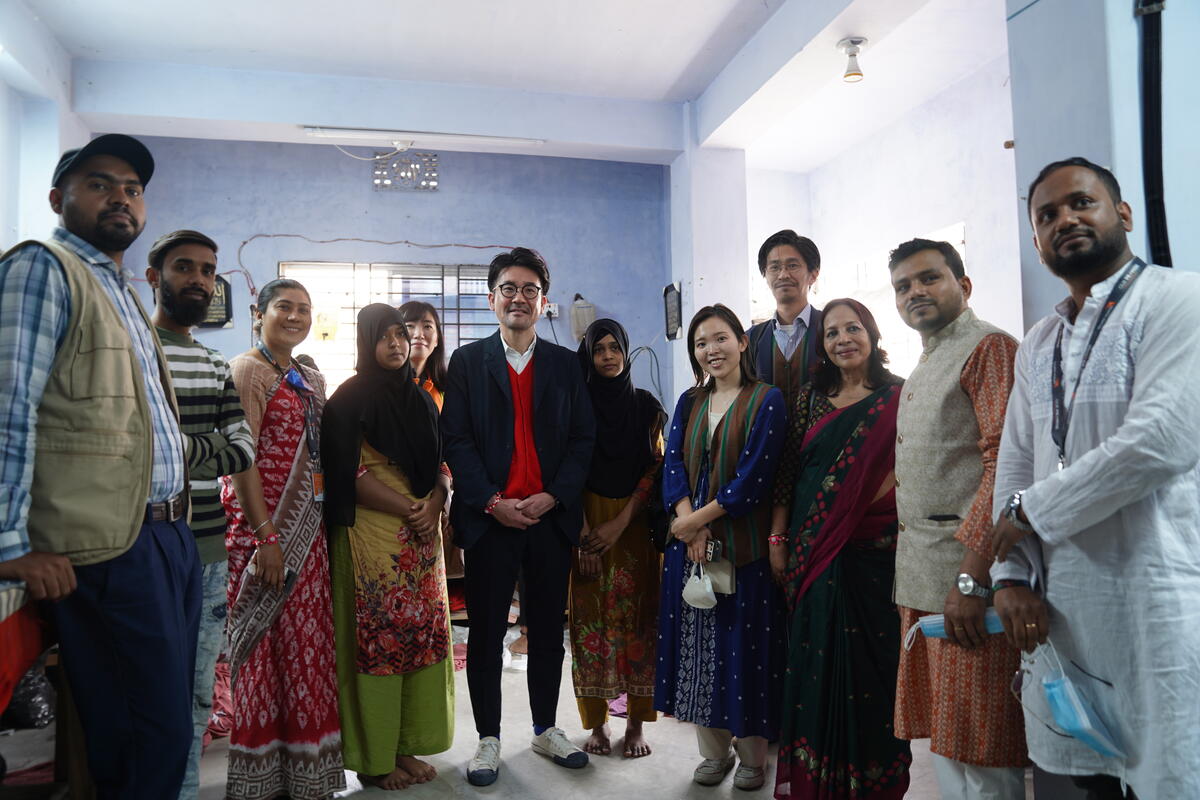 Group of people from Bangladesh standing in a meeting room