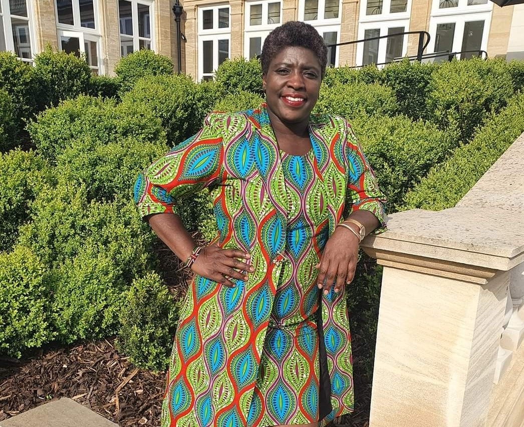 Lydia stands facing the camera with hands on hip