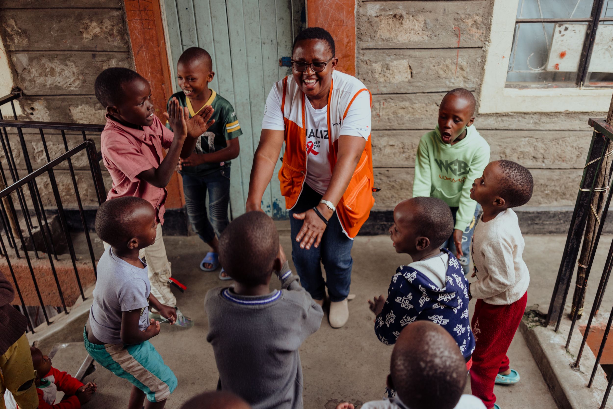 Children having fun with a World Vision staff member