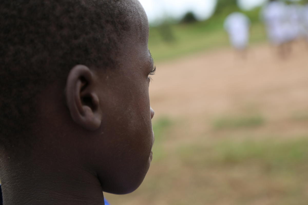 10-year-old Ngala watches children playing football