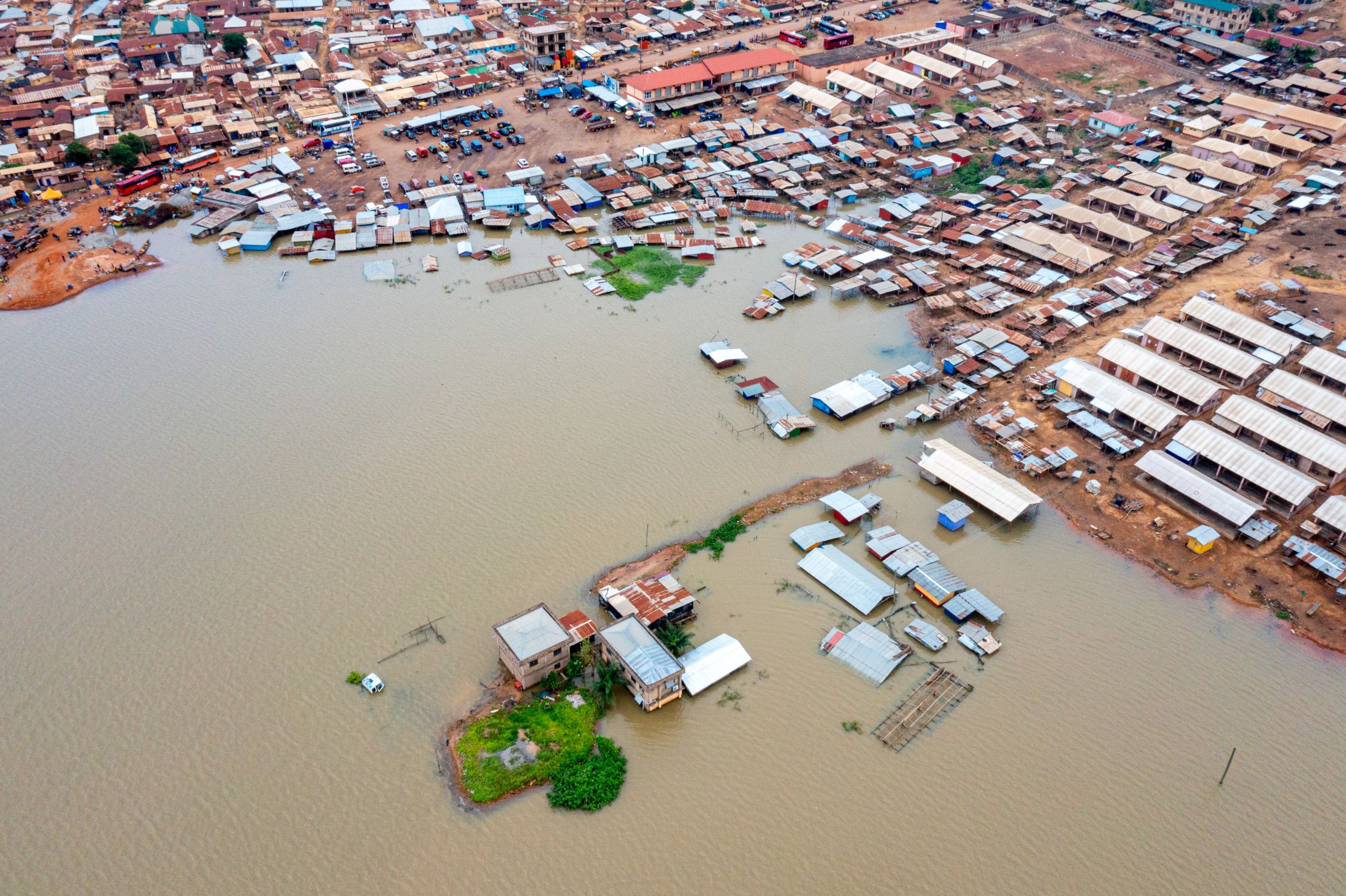 Aerial shot of water covering land: Scene of a flood disaster that affected thousands of people in the Volta Basin, Ghana, 2023