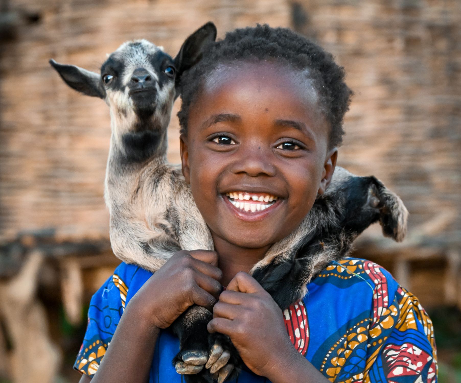 Zambian girl with goat around her neck