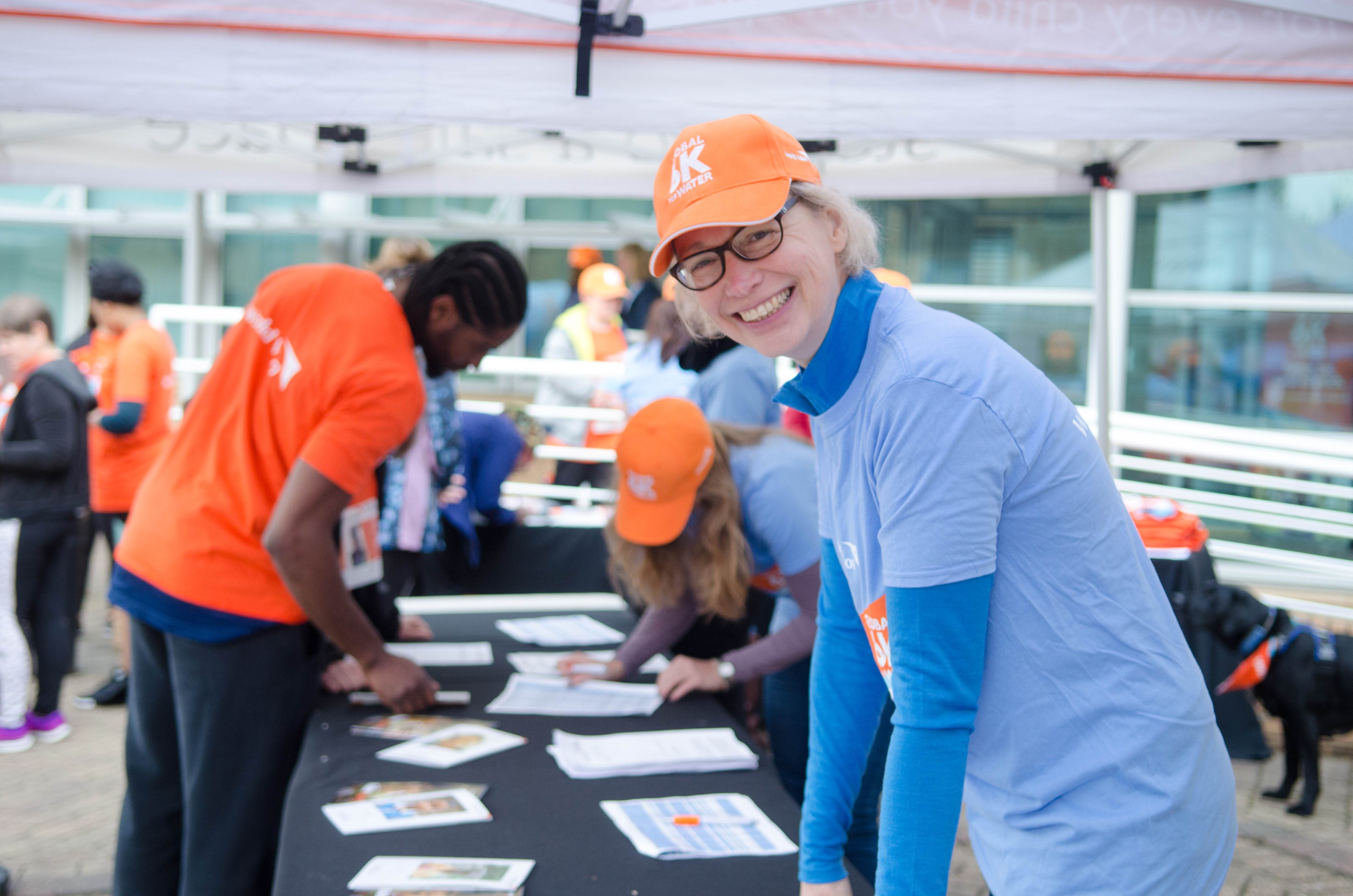 A volunteer in the UK gets involved at a World Vision event helping to register participants