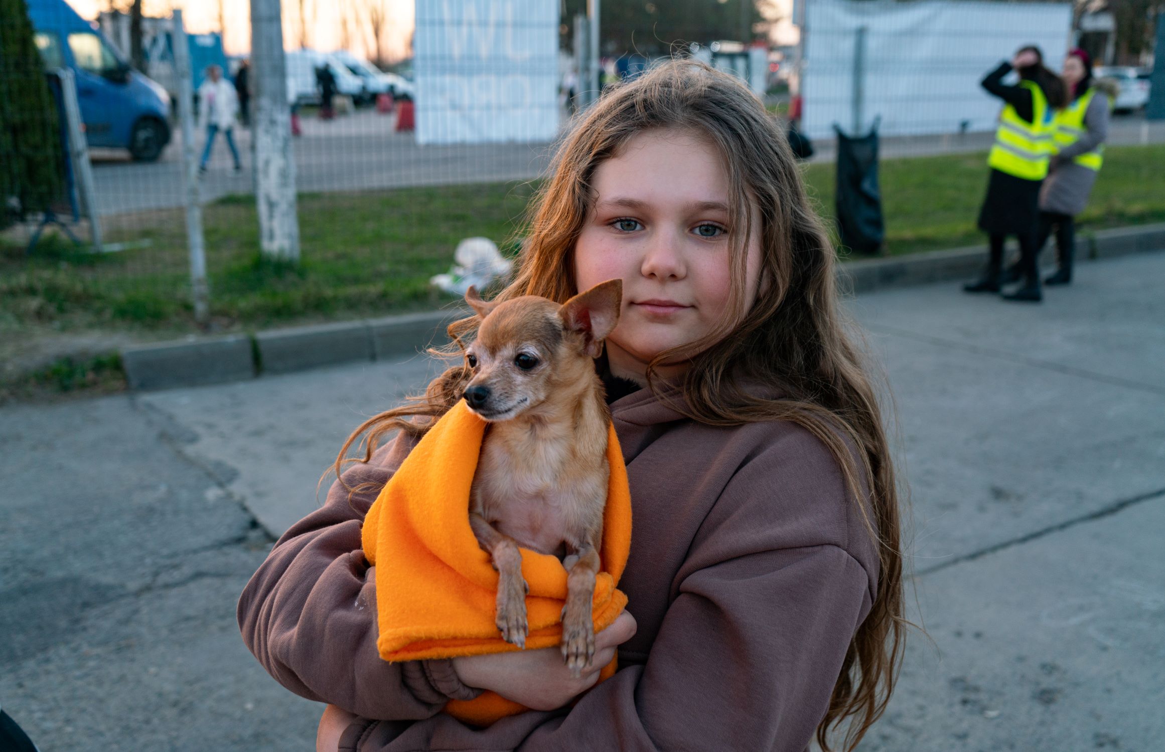 Polina, 12, from Ukraine, holds the dog she's brought across the boarder