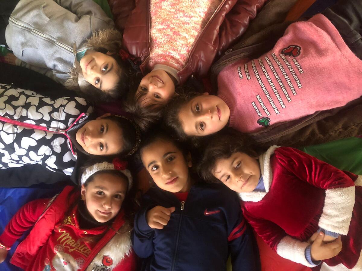 An overhead shot of children laying closely together