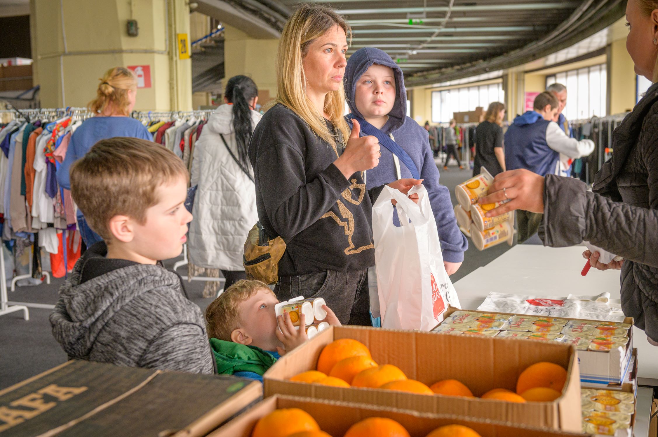 Ukrainian refugee family selecting food in Romania