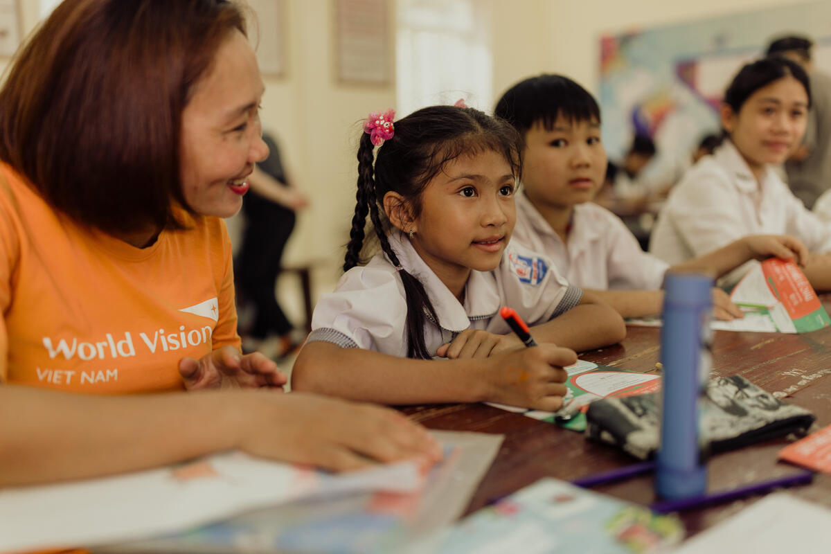Children writing letters to their sponsors