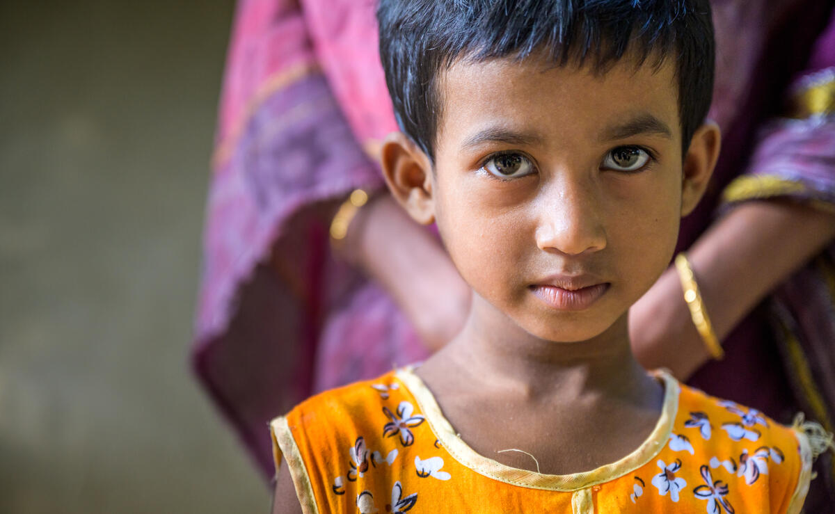 A young girl in Bangladesh faces the camera