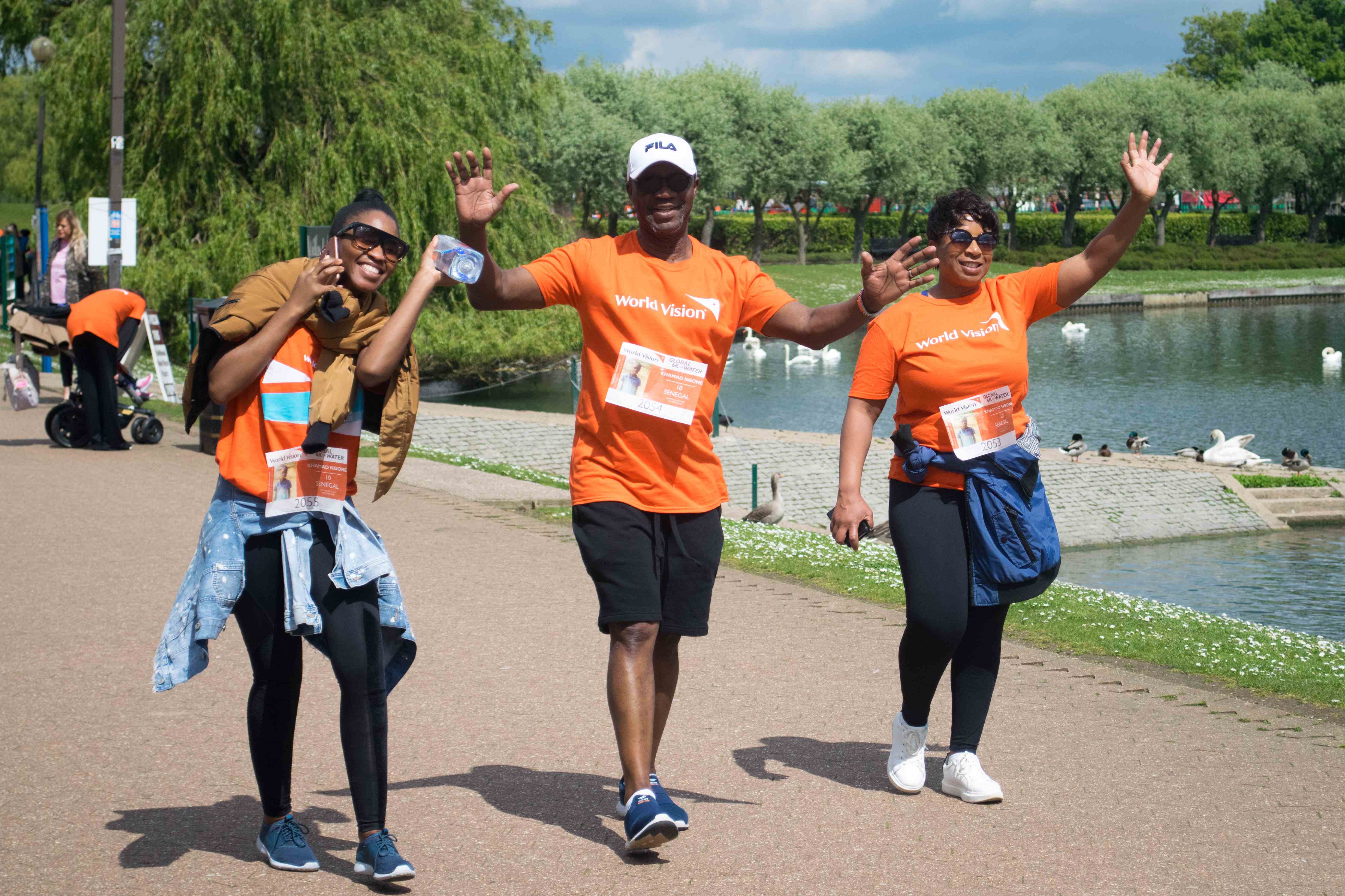 Three people in the UK smile and celebrate whilst doing the Global 6K challenge