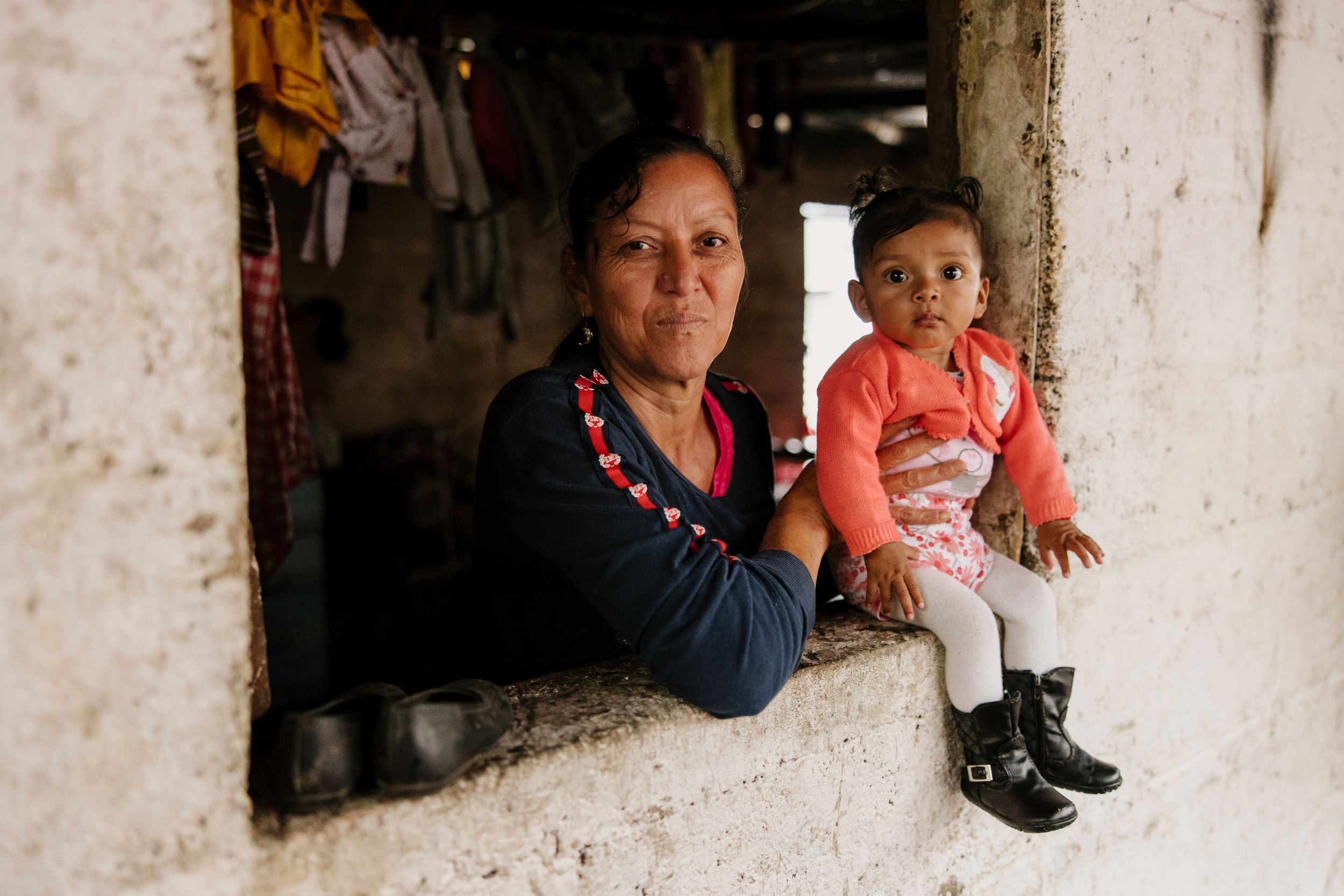 Grandmother and grandchild posing at the window