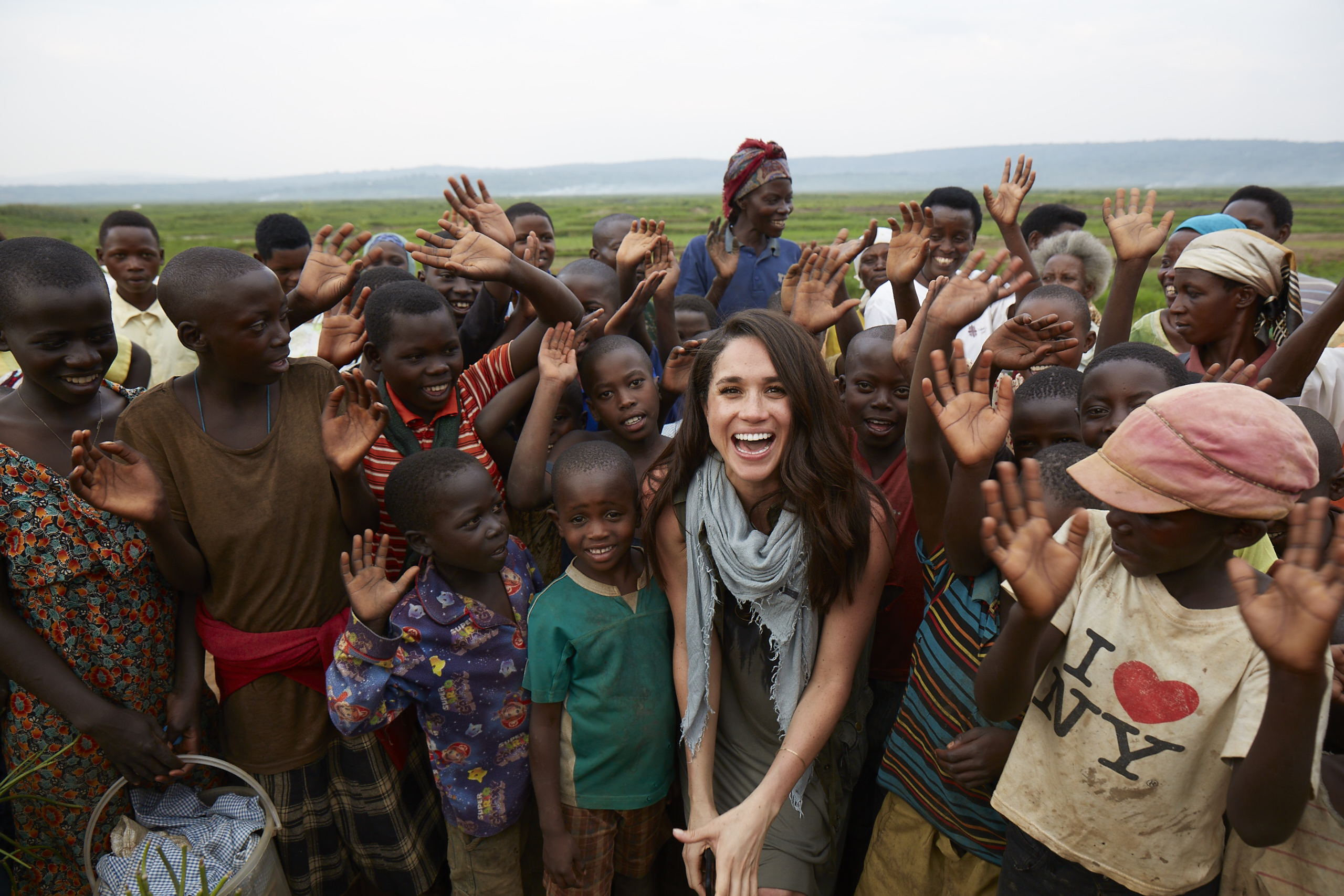 Meghan Markle smiles with a group of people from Rwanda 