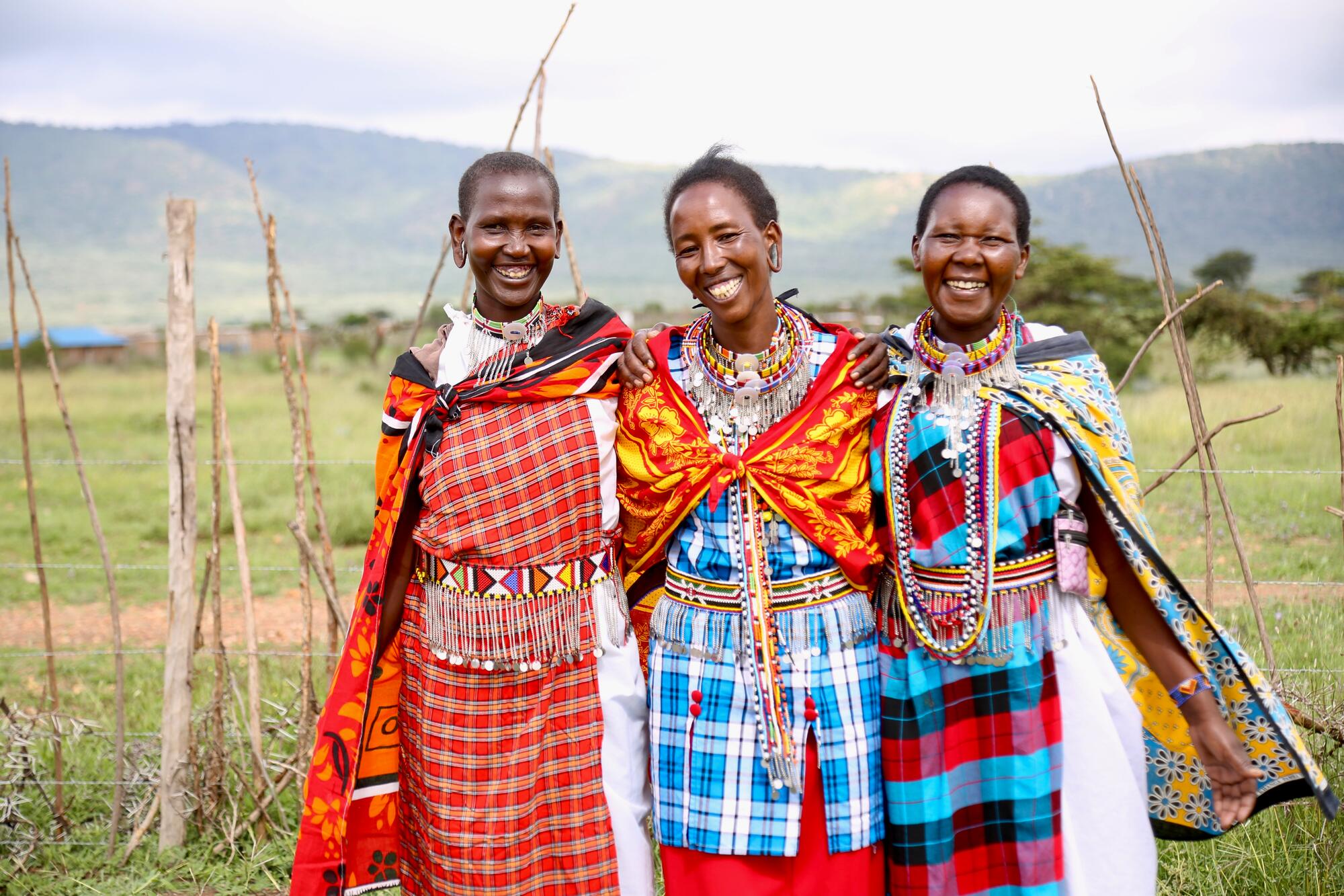 Three women smile at camera in Narok County 