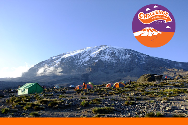 Base camp tents sit below Mt Kilimanjaro in the background 