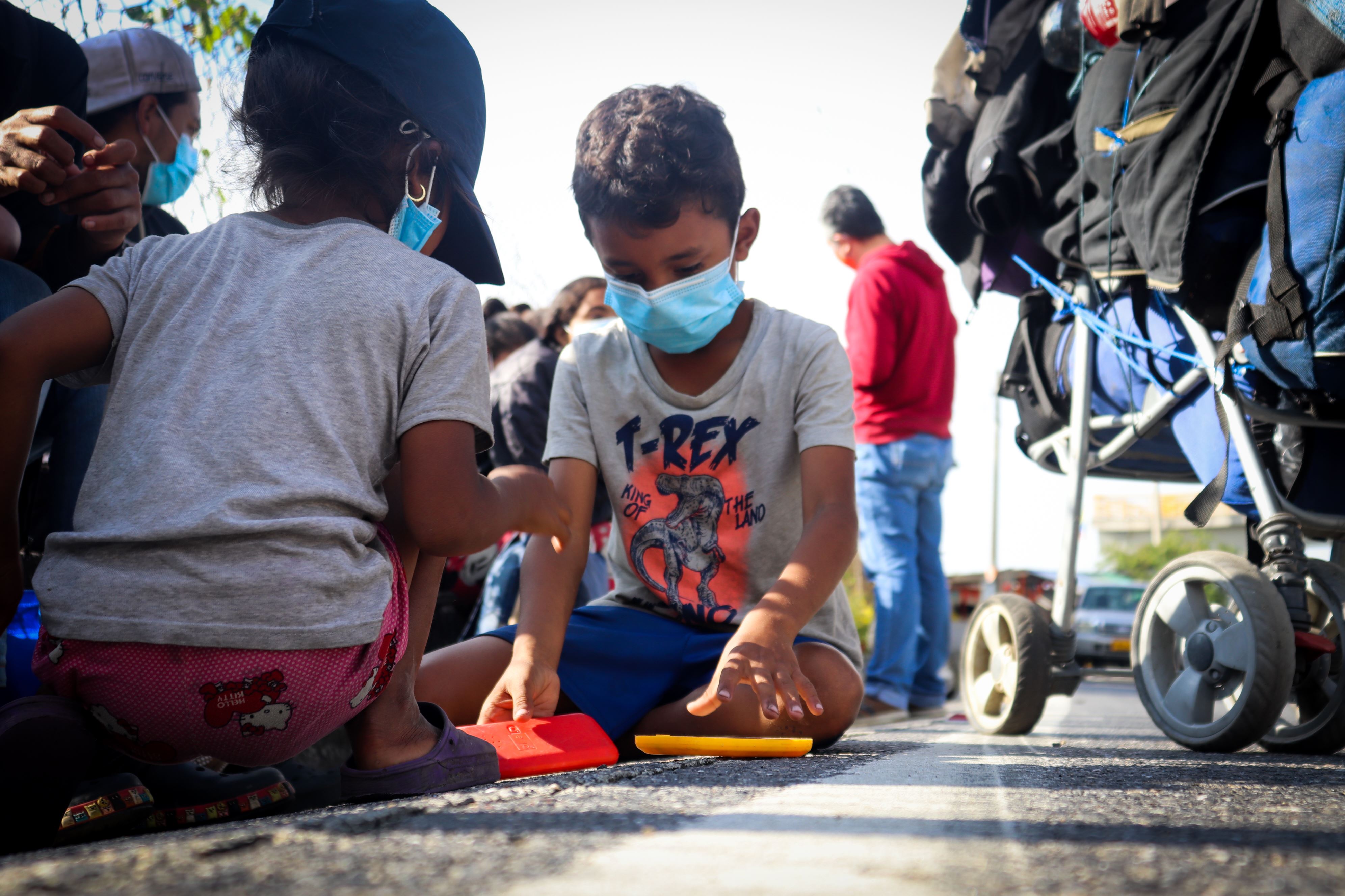 Eliana and her brother Jeiber, sat playing on the road during their long journey to leave Venezuela 