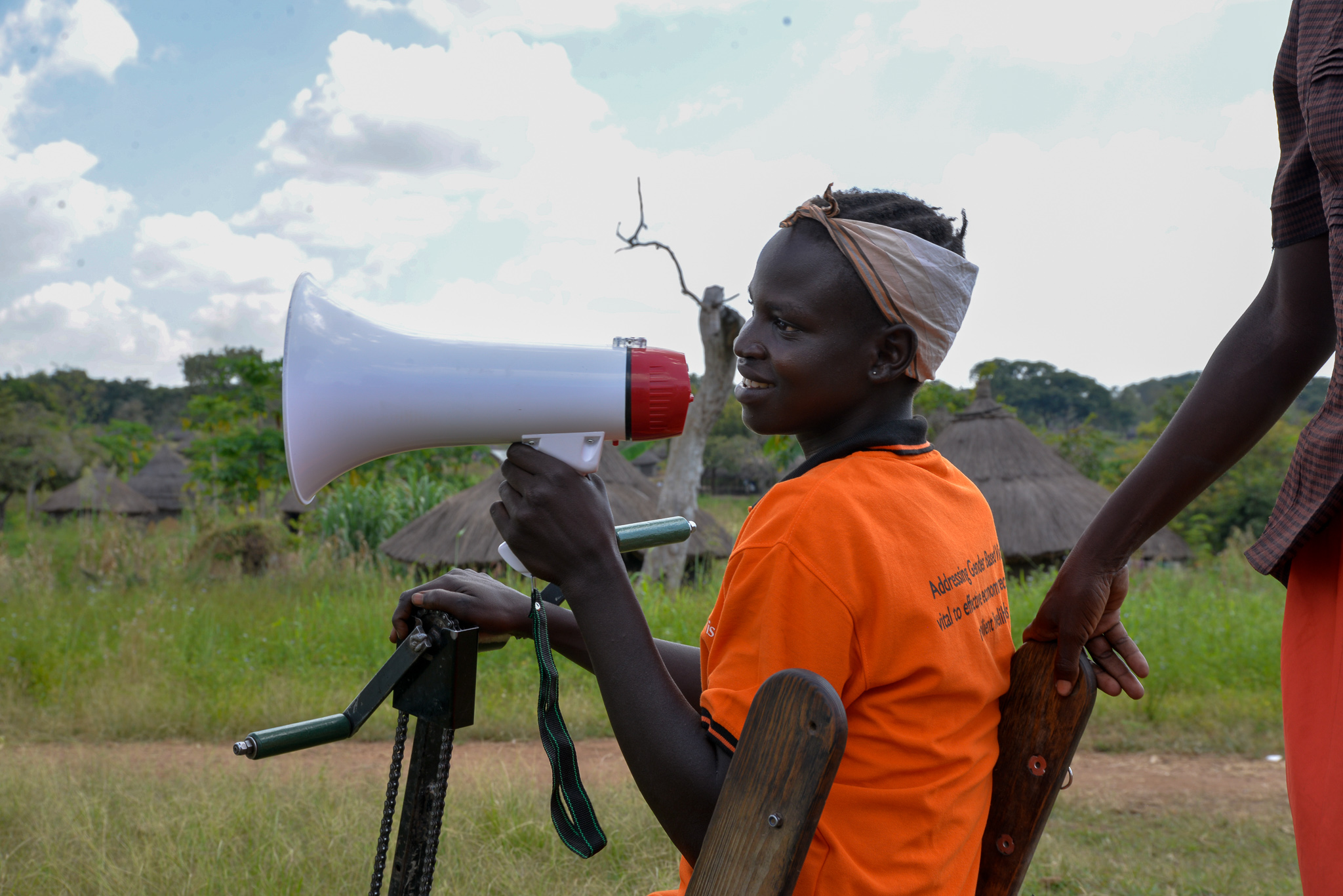 Jane, 14, uses a megaphone to share protection messages with her community