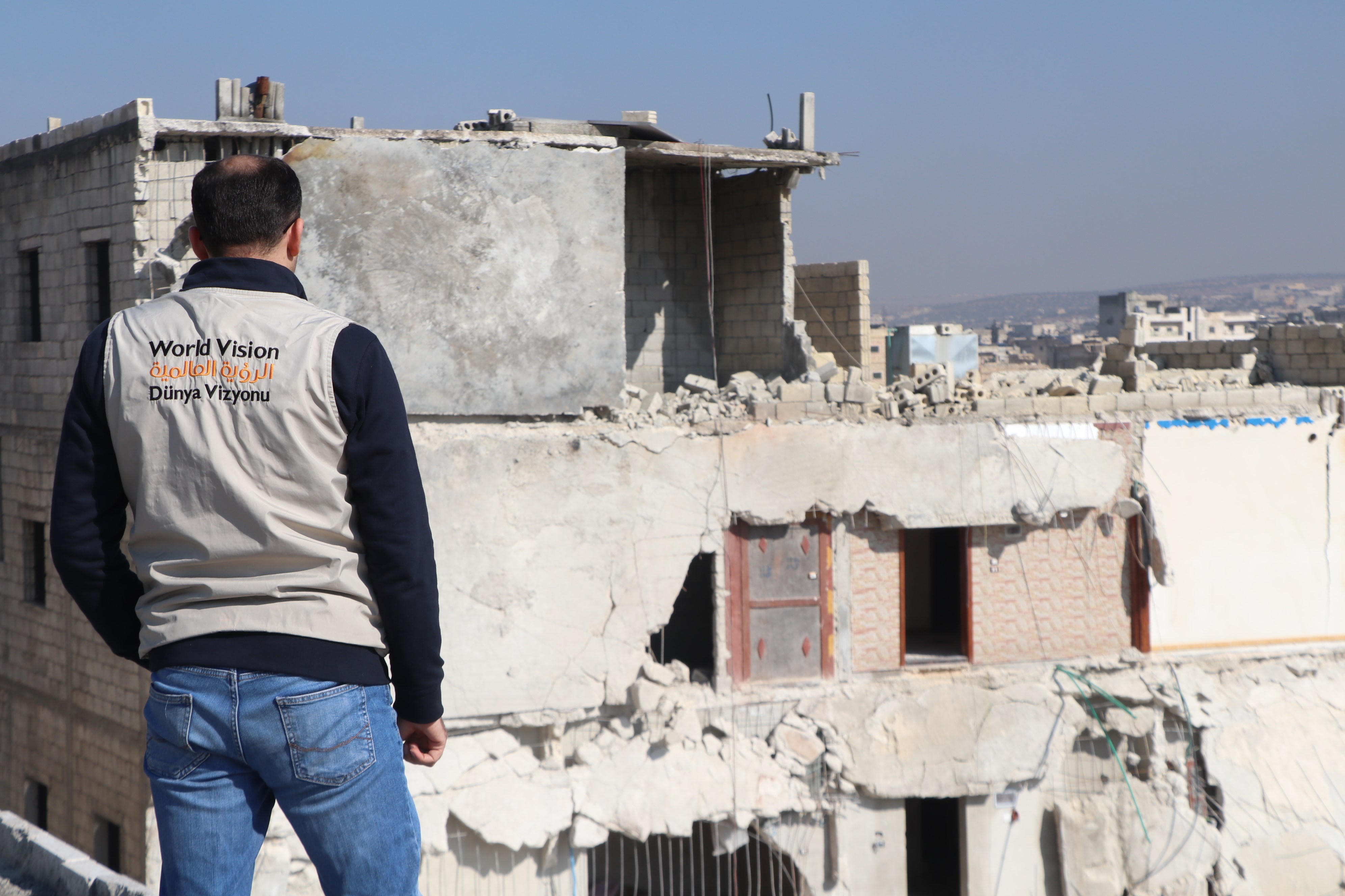 World Vision staff looking over the rubble left behind after the Turkey-Syria earthquake
