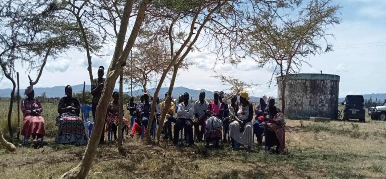 Girl in Afghanistan smiles broadly as she washes her hands in clean water from a tap