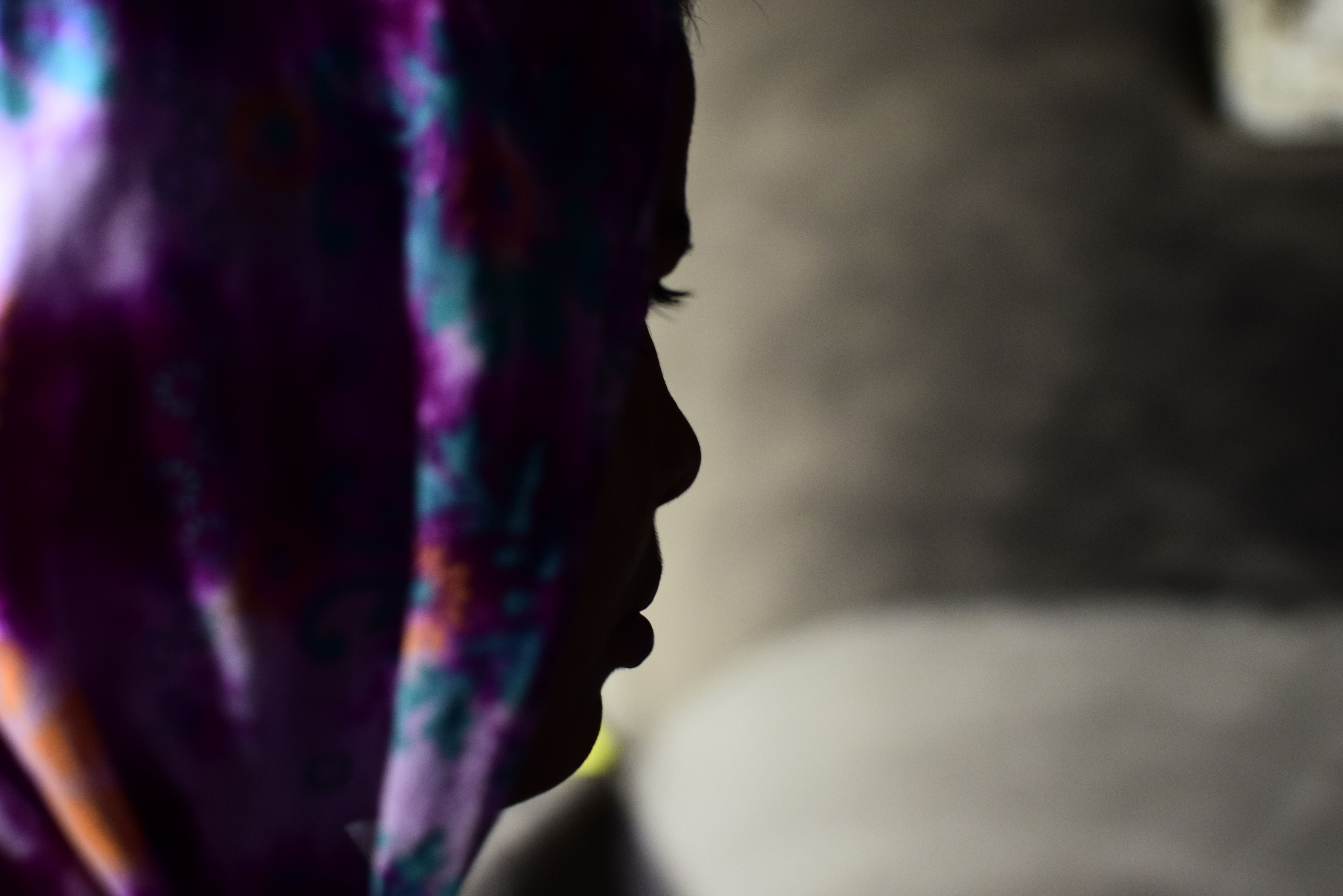 Silhouette portrait of a girl wearing colourful headscarf