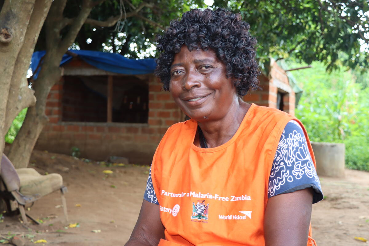 A community health worker from Zambia smiles at the camera