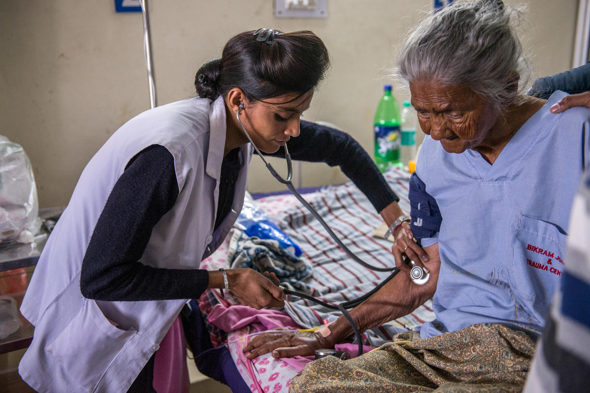 Nurse in India looks after an elderly woman