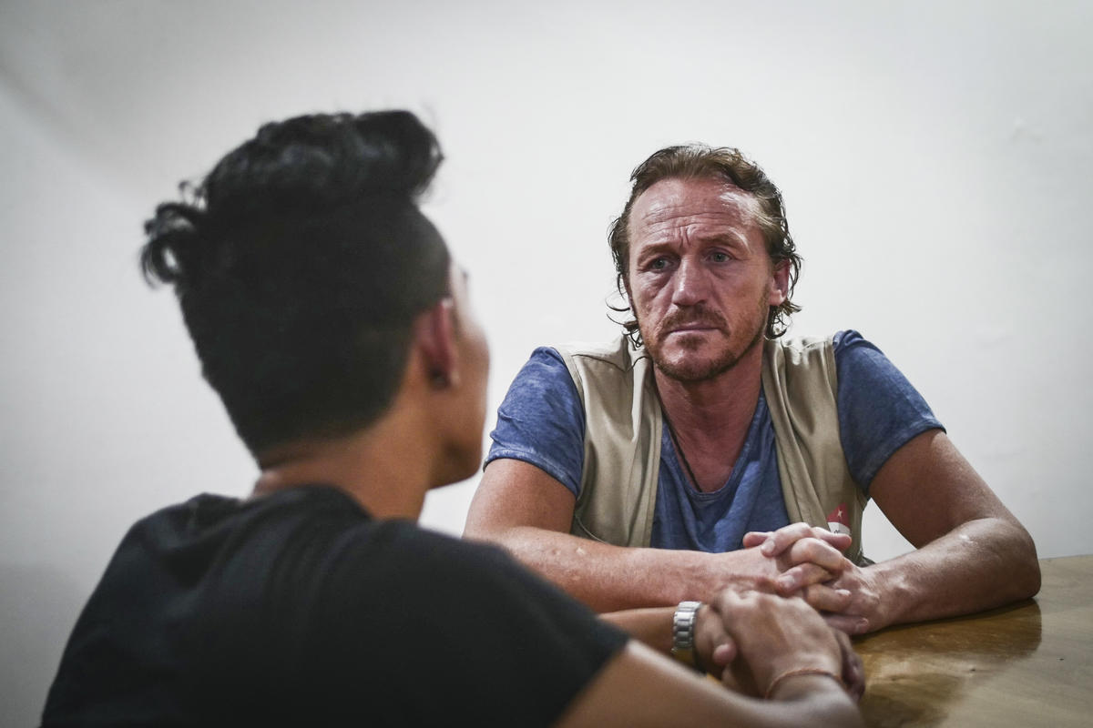 Jerome Flynn sits in a room in Myanmar, talking to a former child soldier, we can only see the back of his head.