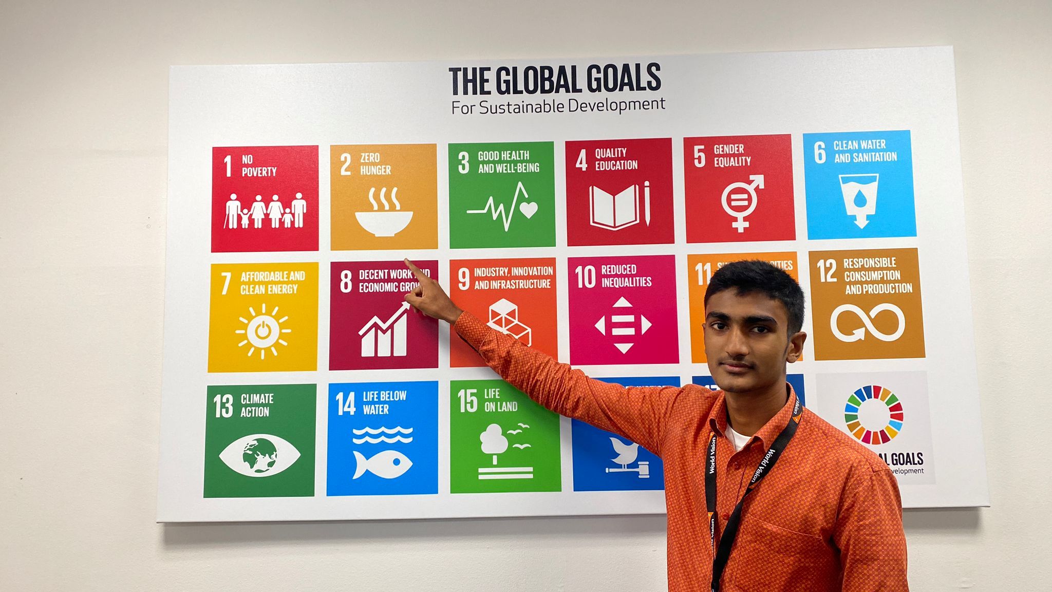 Young Bangladeshi man pointing to UN Sustainable goal, zero hunger