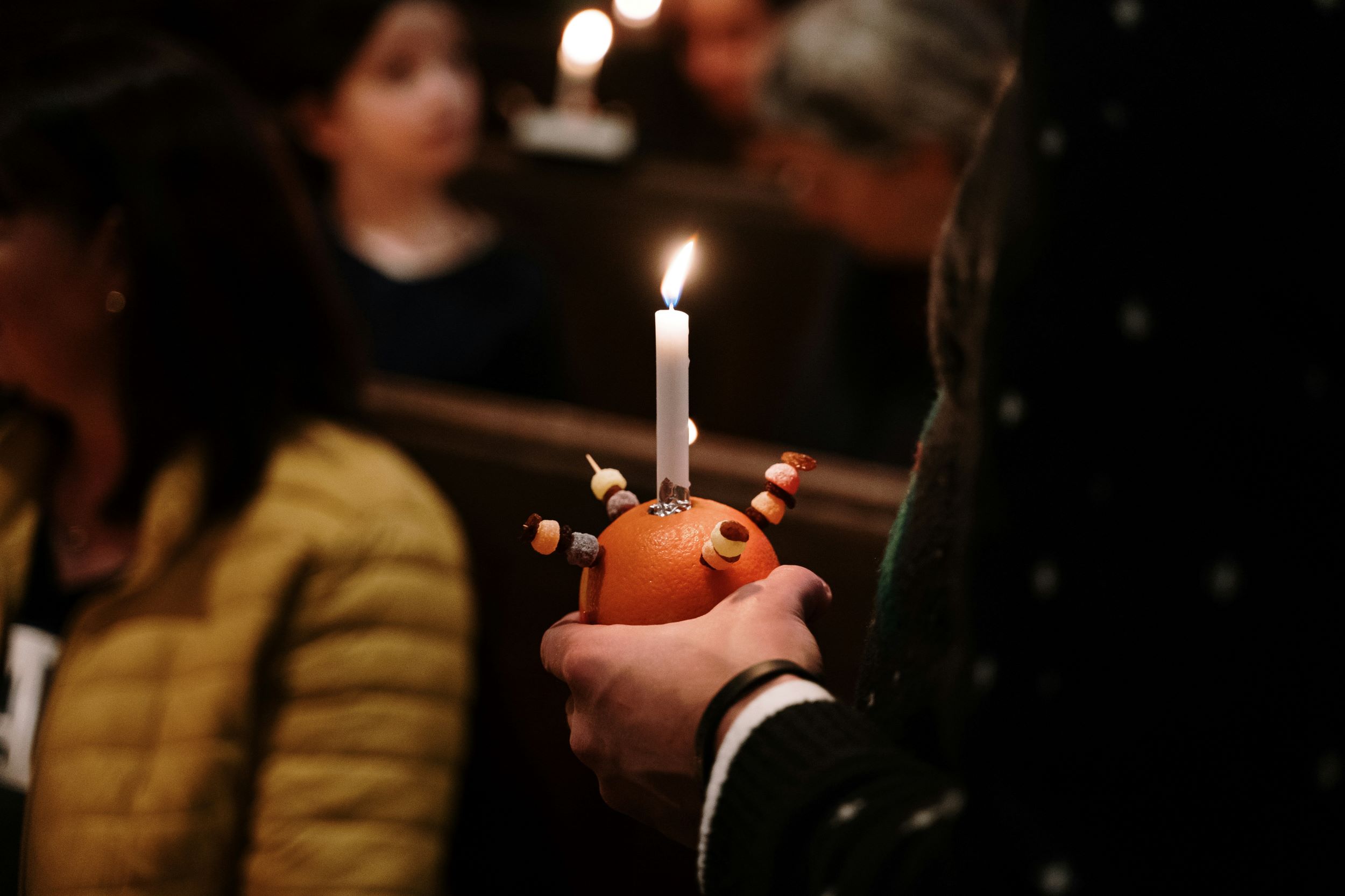 Person holding Christingle at a church services